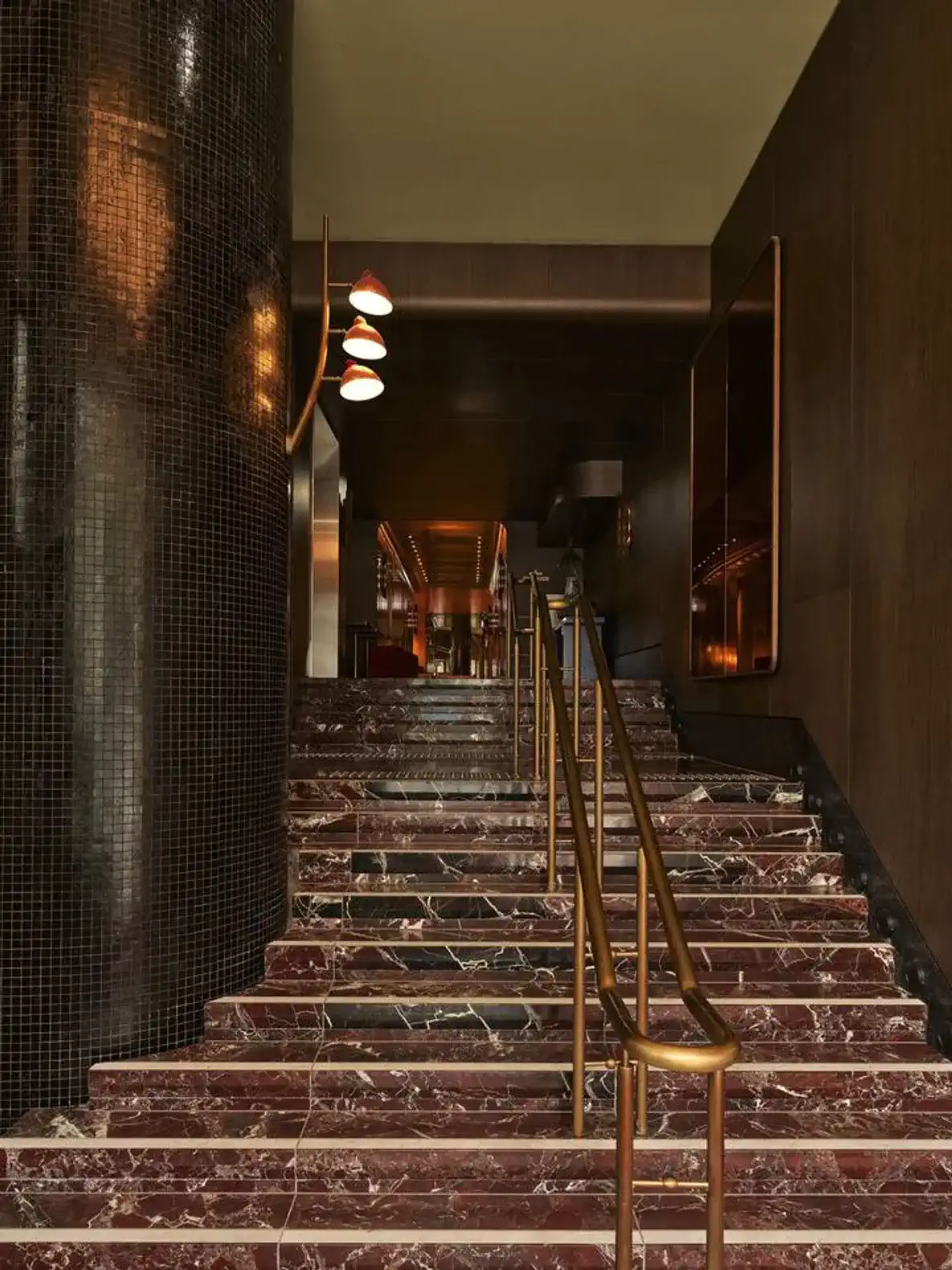 Elegant staircase with marble steps and modern lighting fixtures