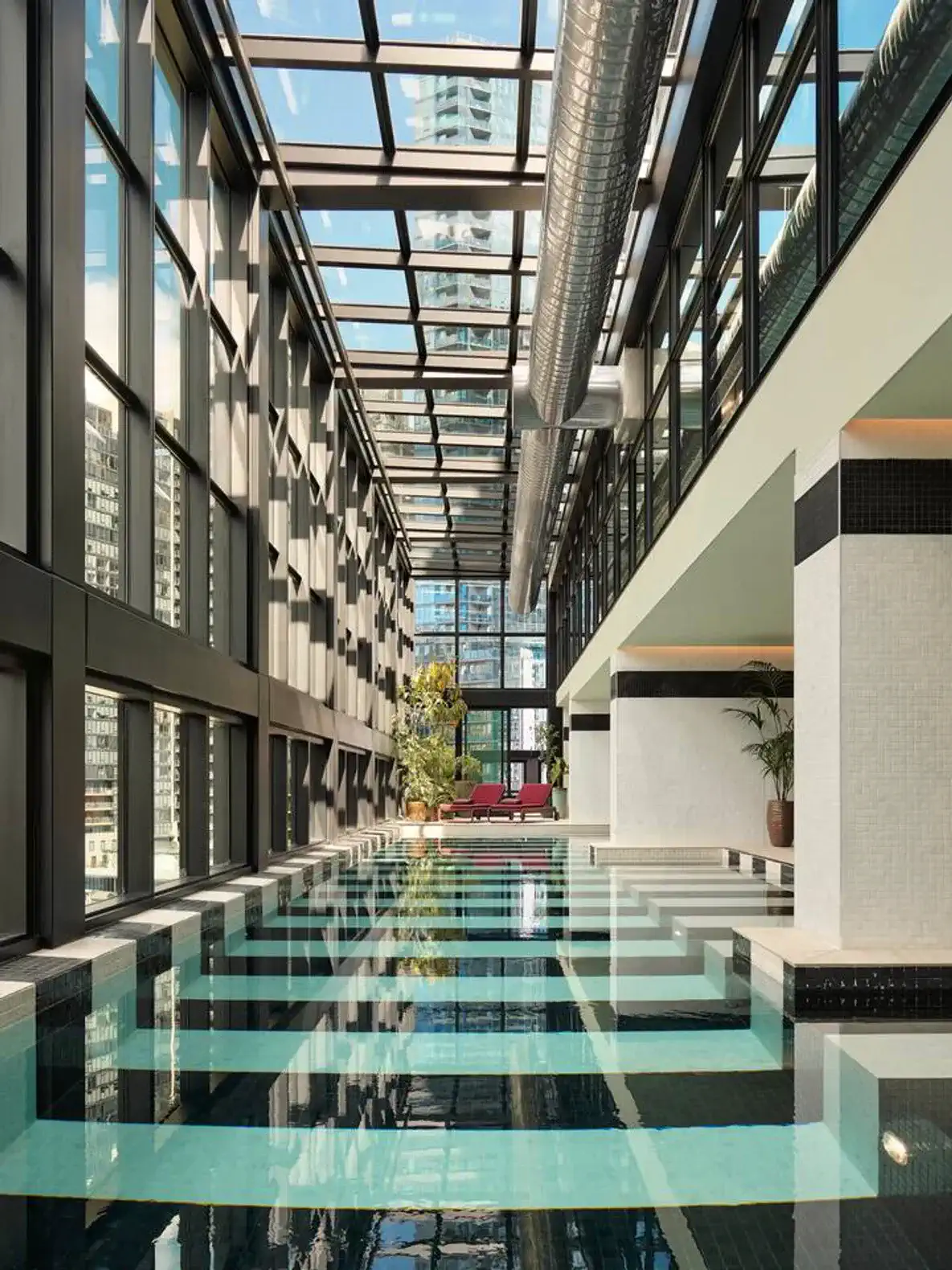 Indoor swimming pool with large windows and modern design