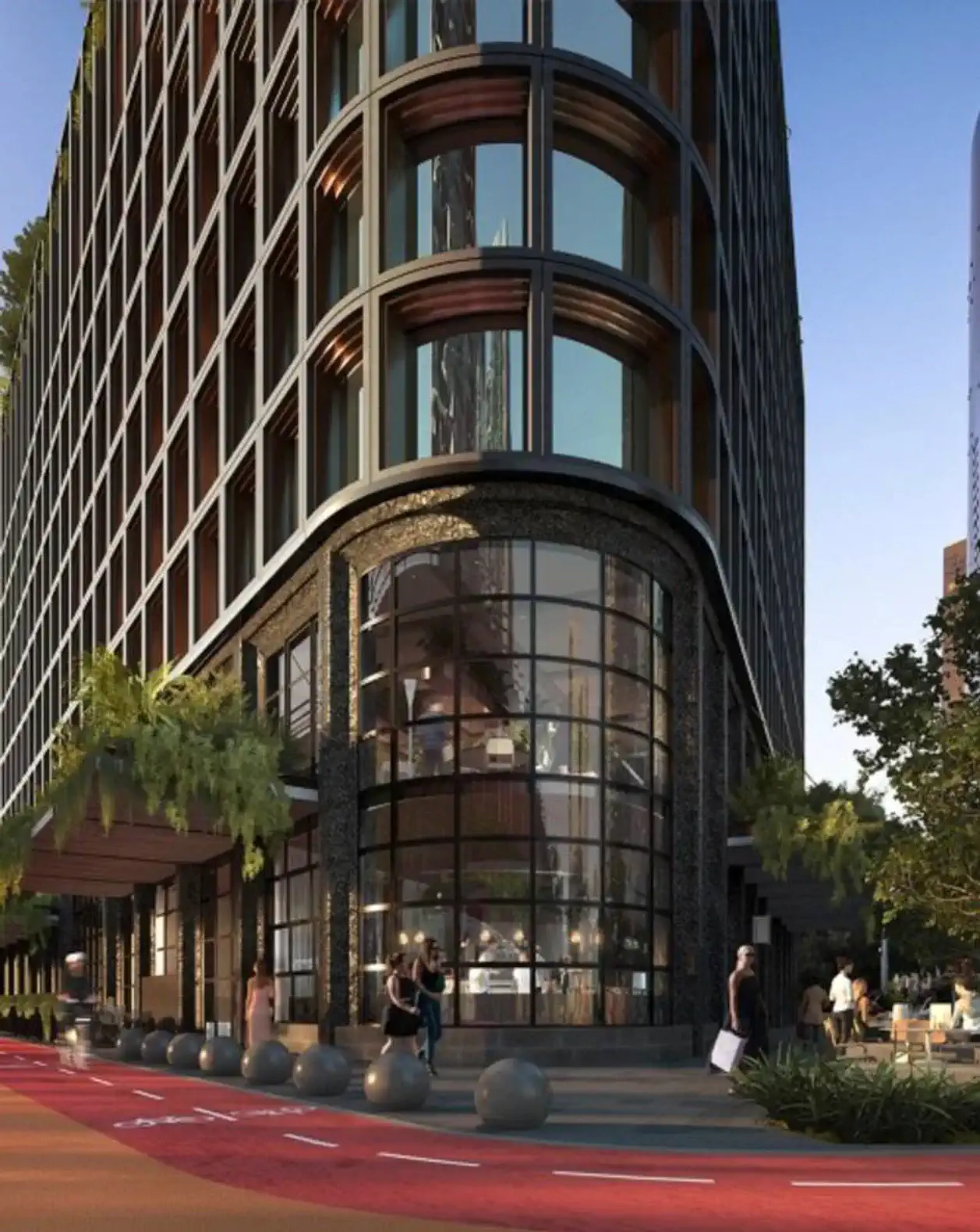Modern building entrance with large glass windows and landscaped surroundings