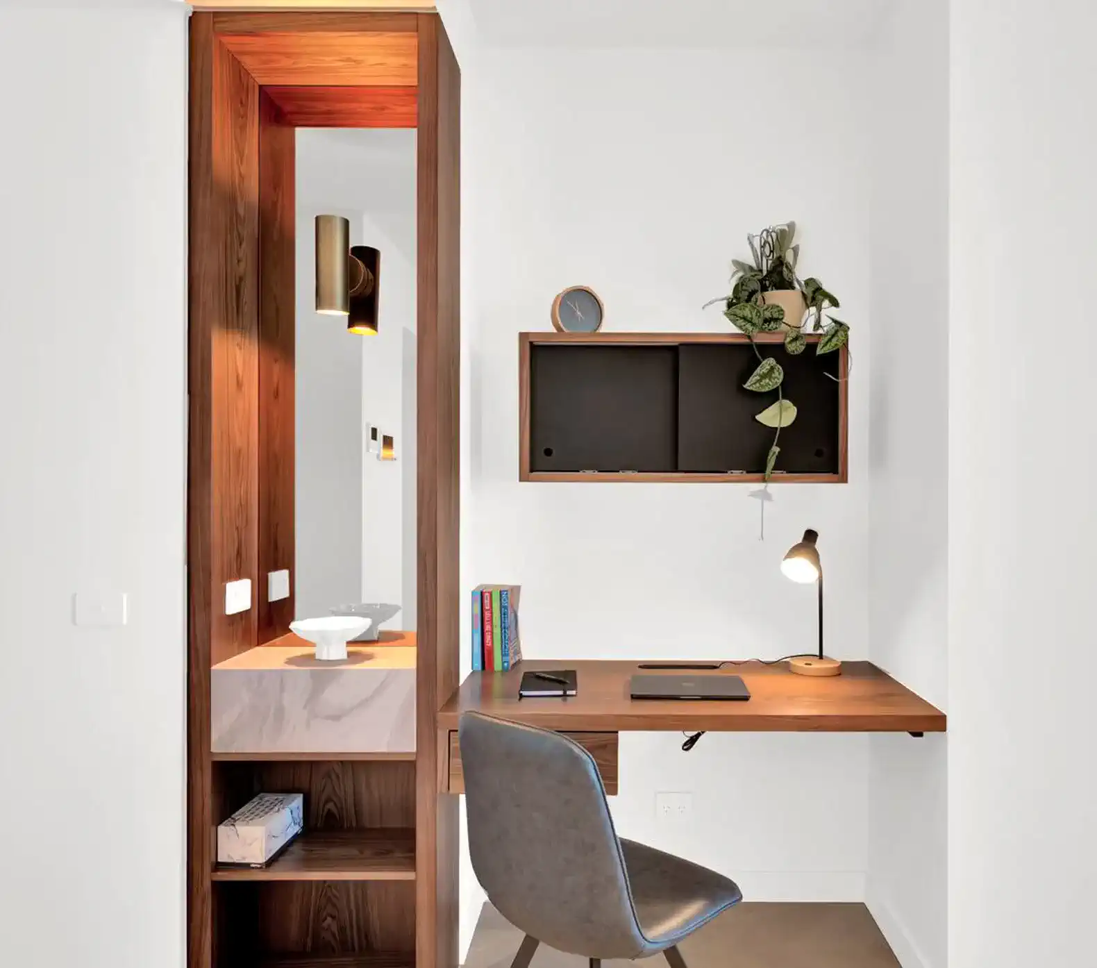 Cozy workspace with a wooden desk, chair, and decorative plants
