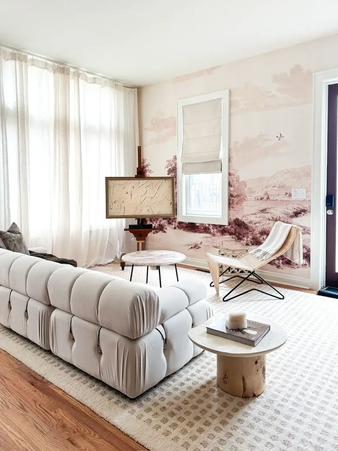Stylish living room with a plush sofa, art on the wall, and natural light