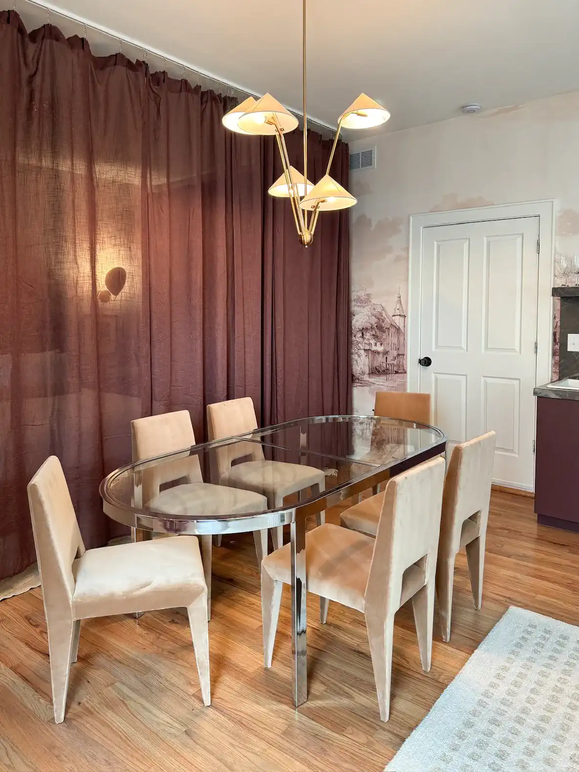 Elegant dining area with a modern table and stylish chairs under a unique light fixture