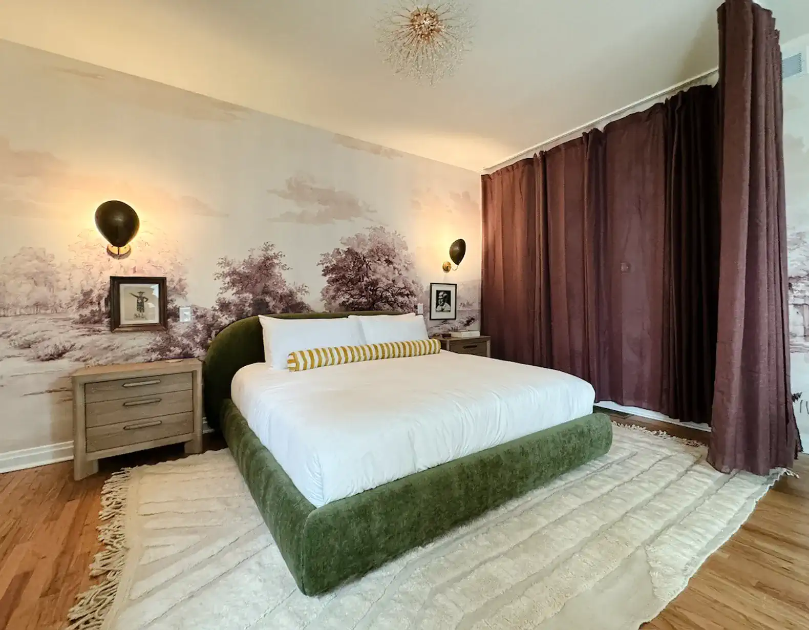 Stylish master bedroom with a green bed, elegant decor, and soft lighting