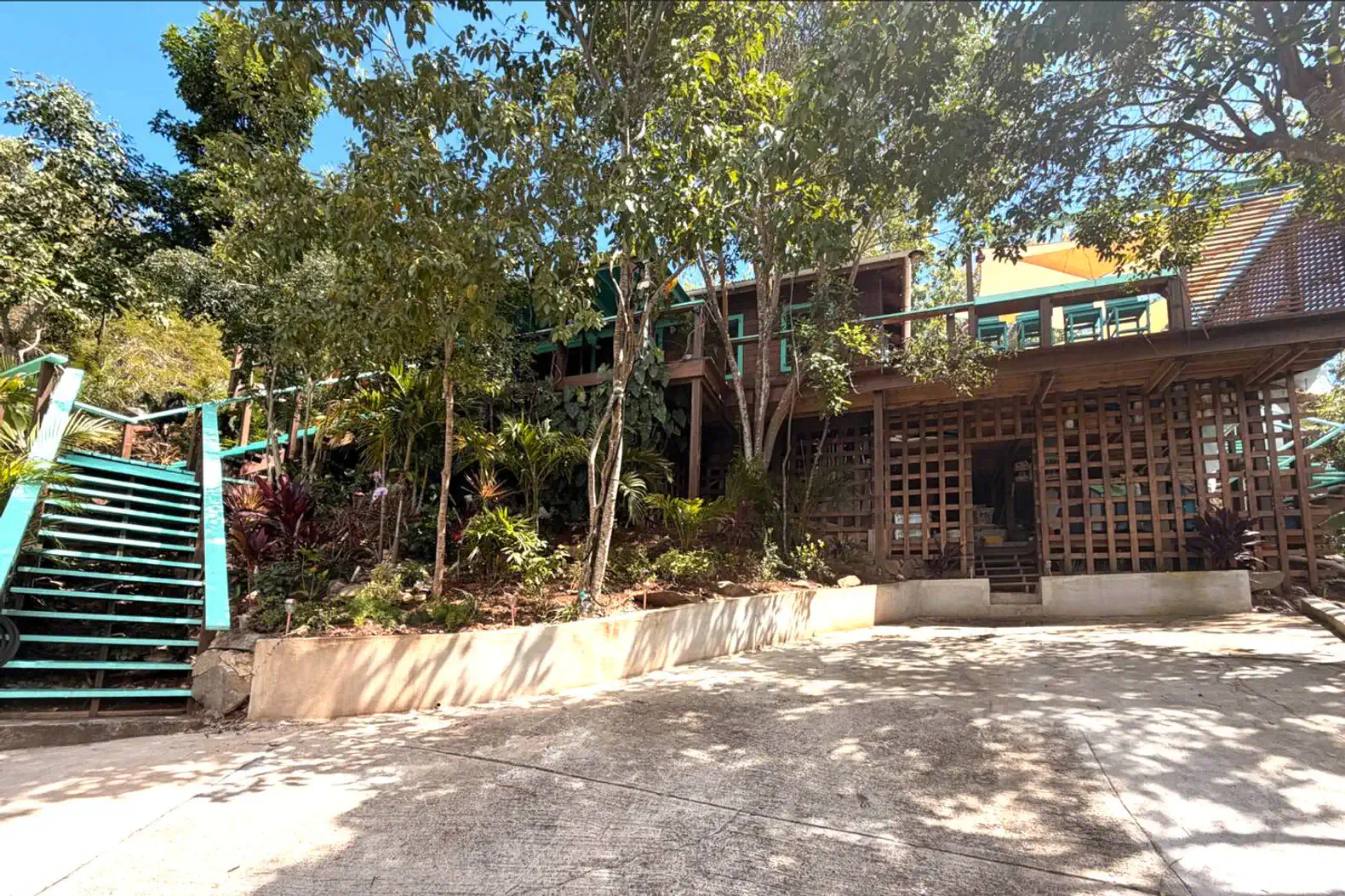 Exterior view of Cocoa Tea Villa surrounded by lush greenery and stairs leading to the entrance