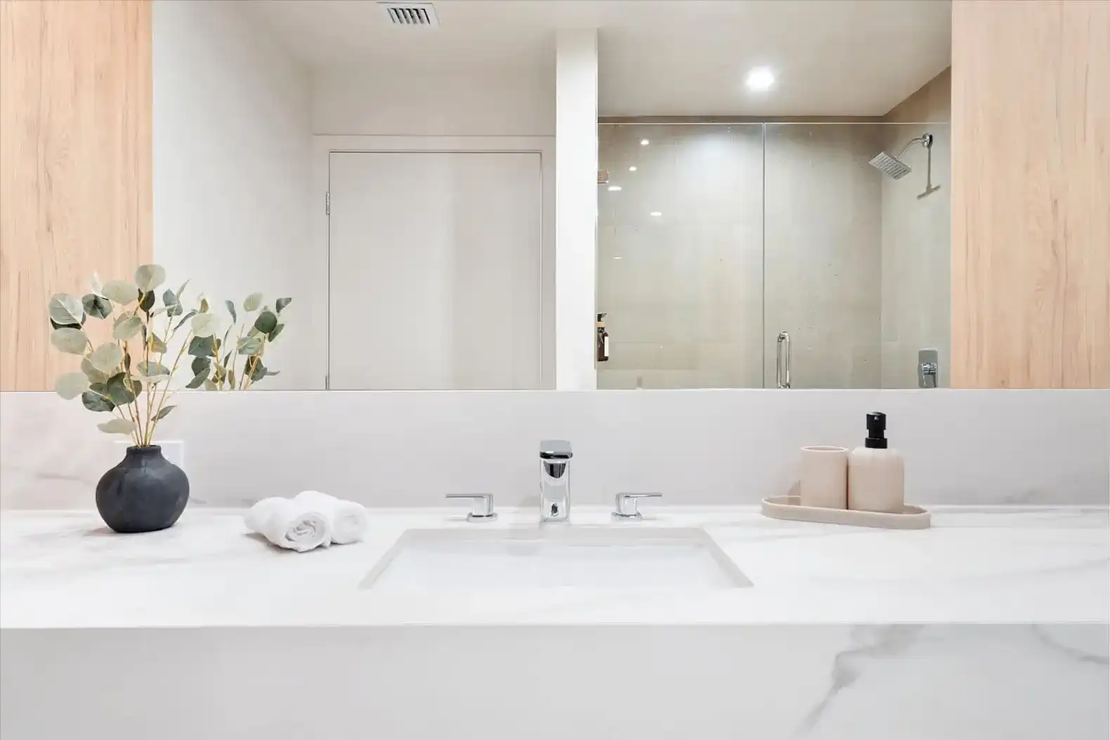 Modern bathroom with sleek marble sink and glass shower