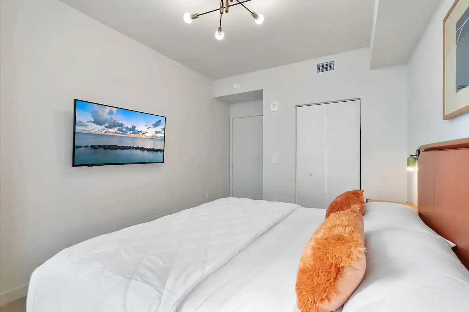 Cozy master bedroom with a large bed and wall-mounted TV