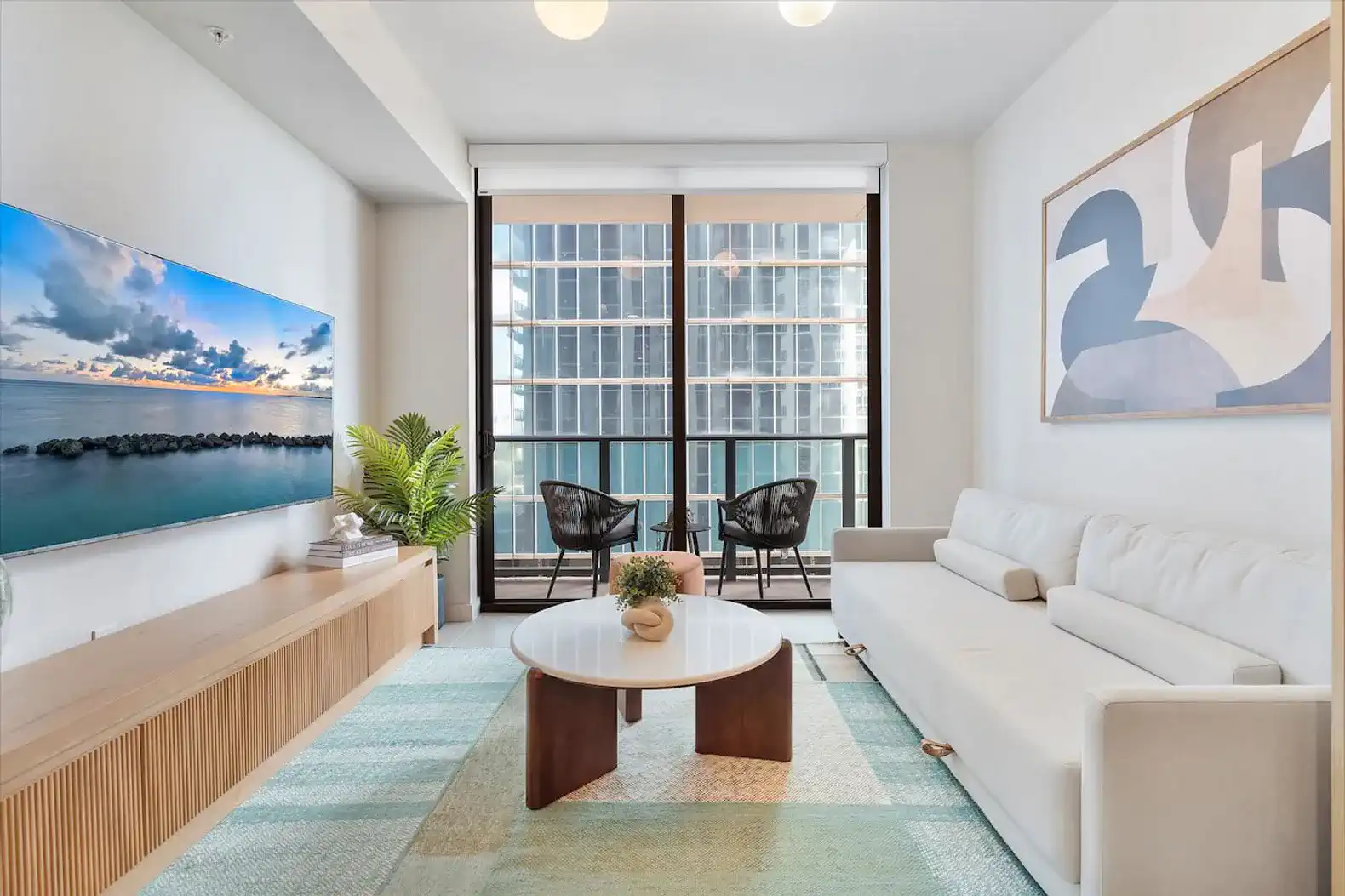Bright living room with modern furniture and city views through large windows