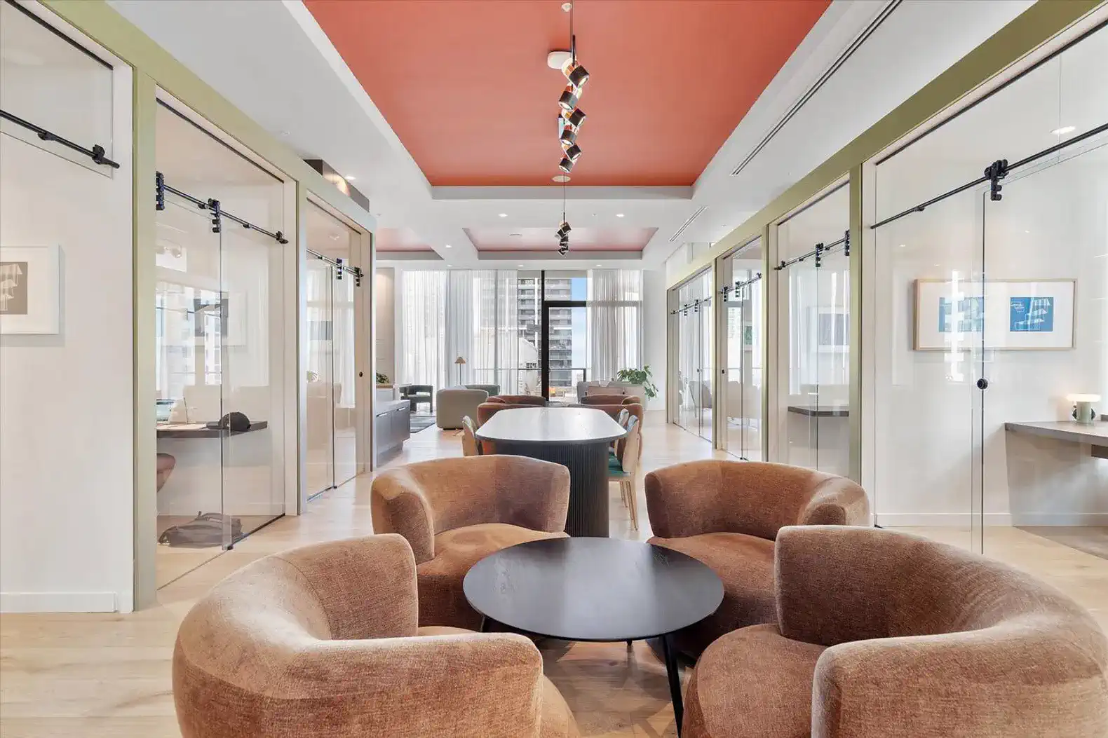 Modern lounge area with stylish seating and glass partitions