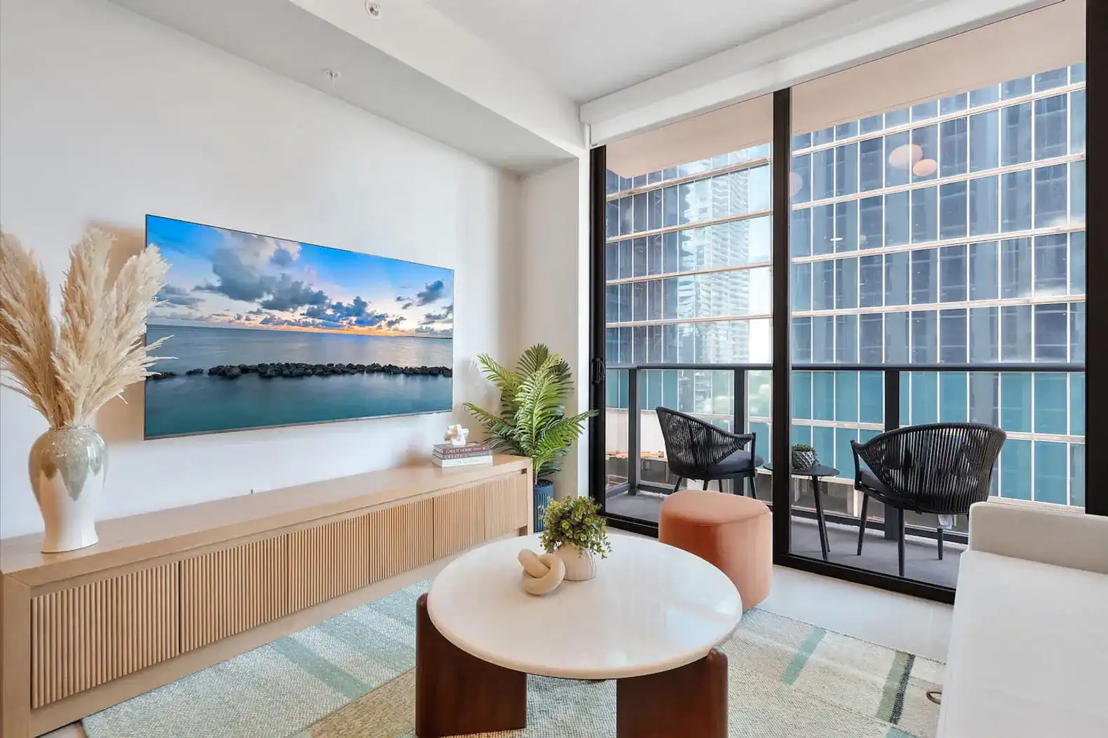 Stylish living room with modern decor and large windows showcasing city views