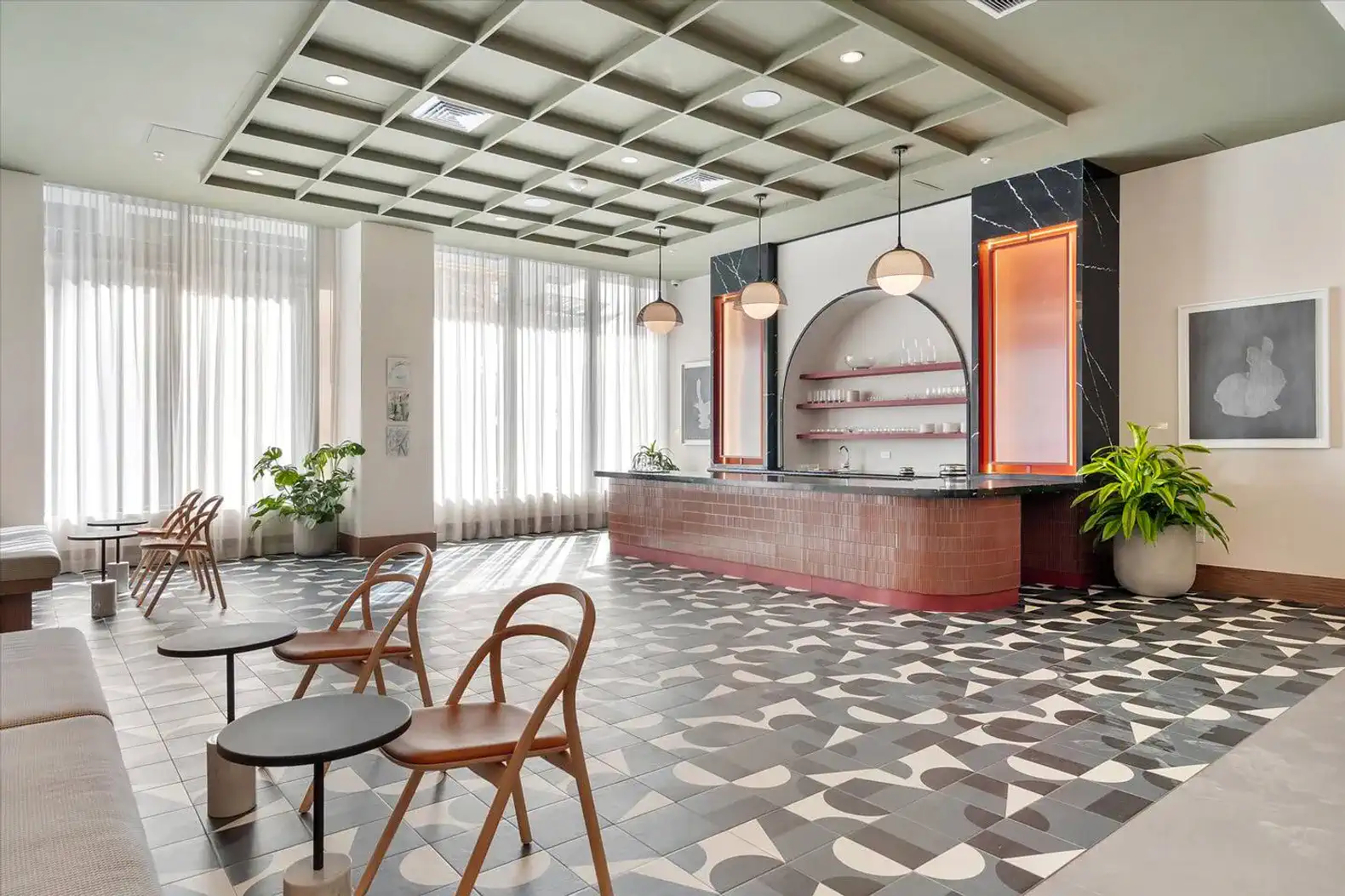 Stylish lobby area with modern decor, patterned flooring, and large windows