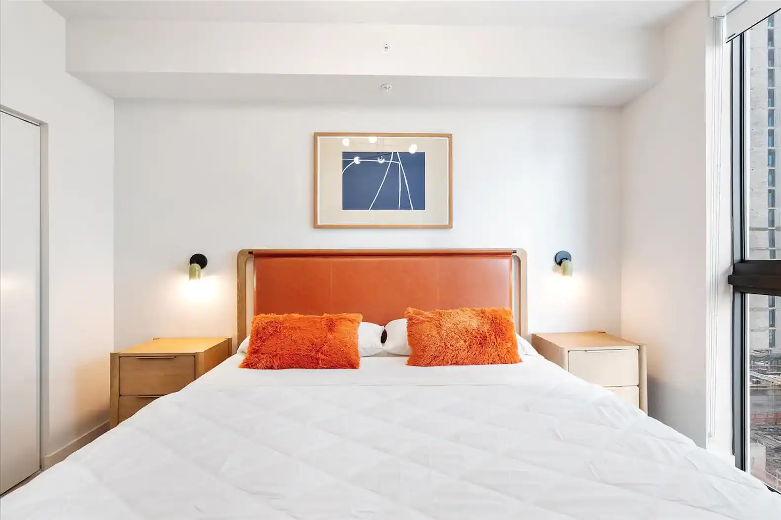 Cozy master bedroom with orange accents and modern decor