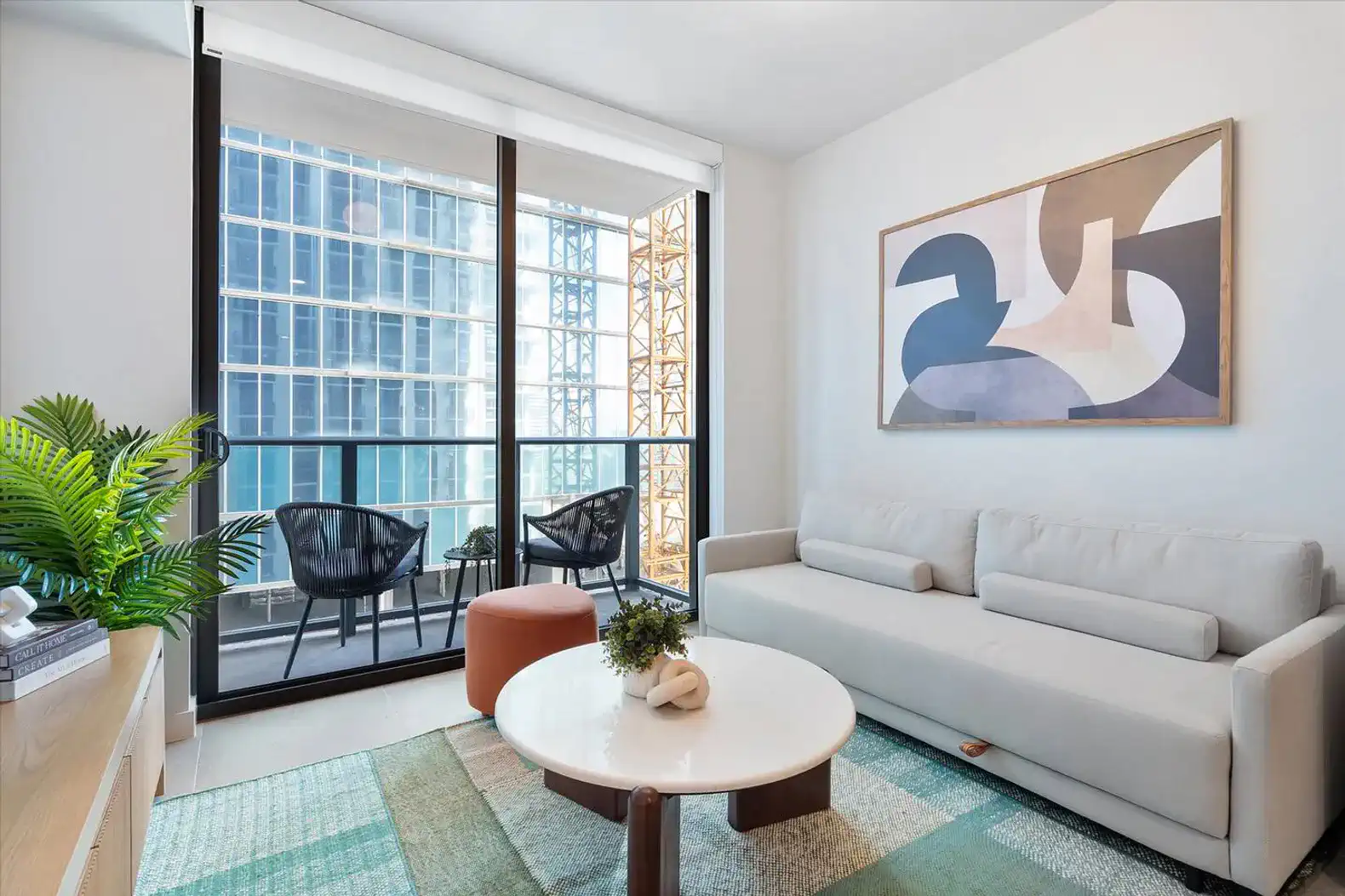 Cozy living room with modern furniture and city views through large windows