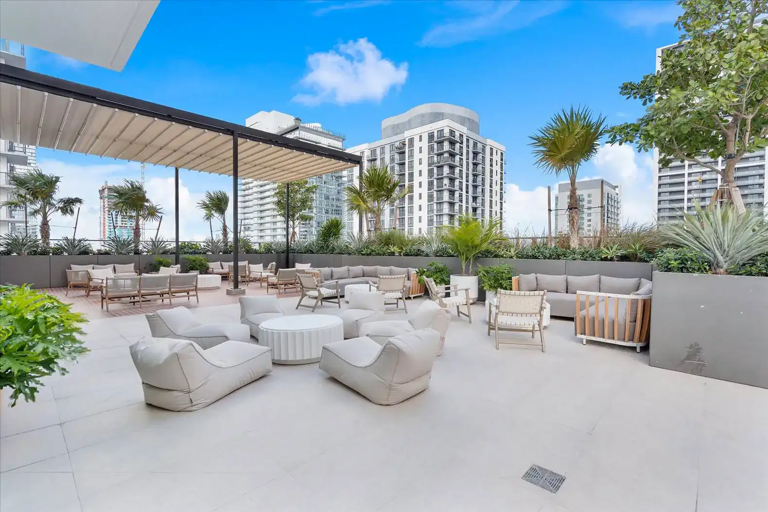 Spacious outdoor lounge area with comfortable seating and greenery