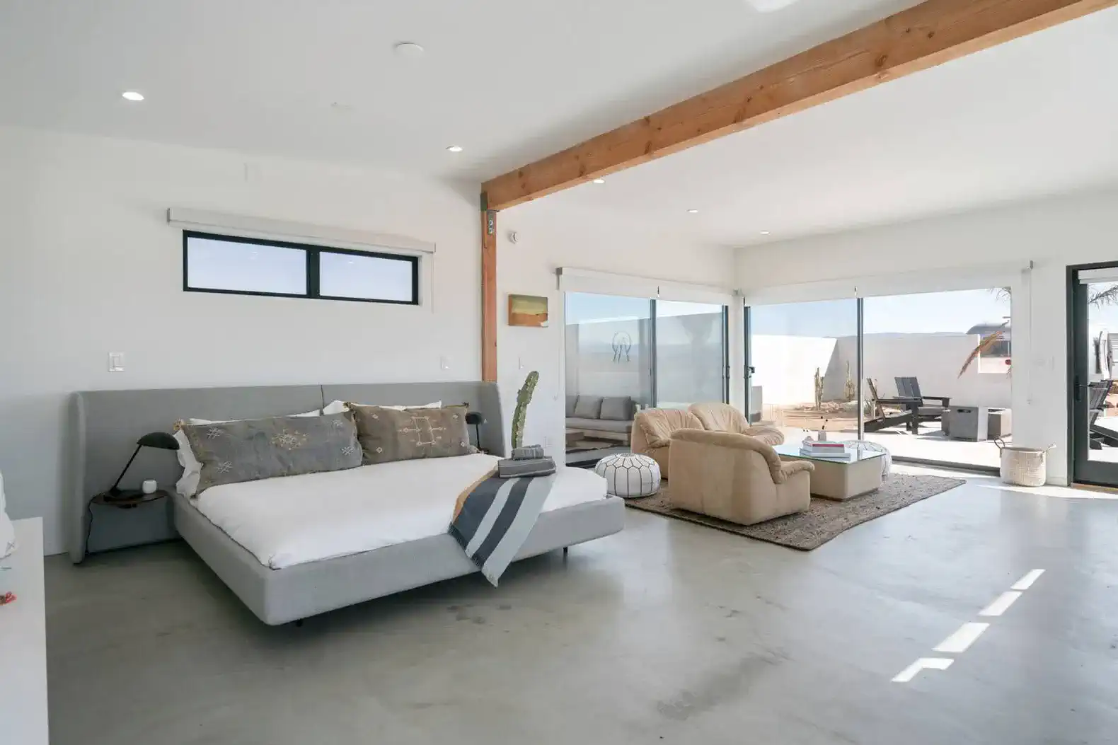 Spacious living area with large windows and modern furnishings