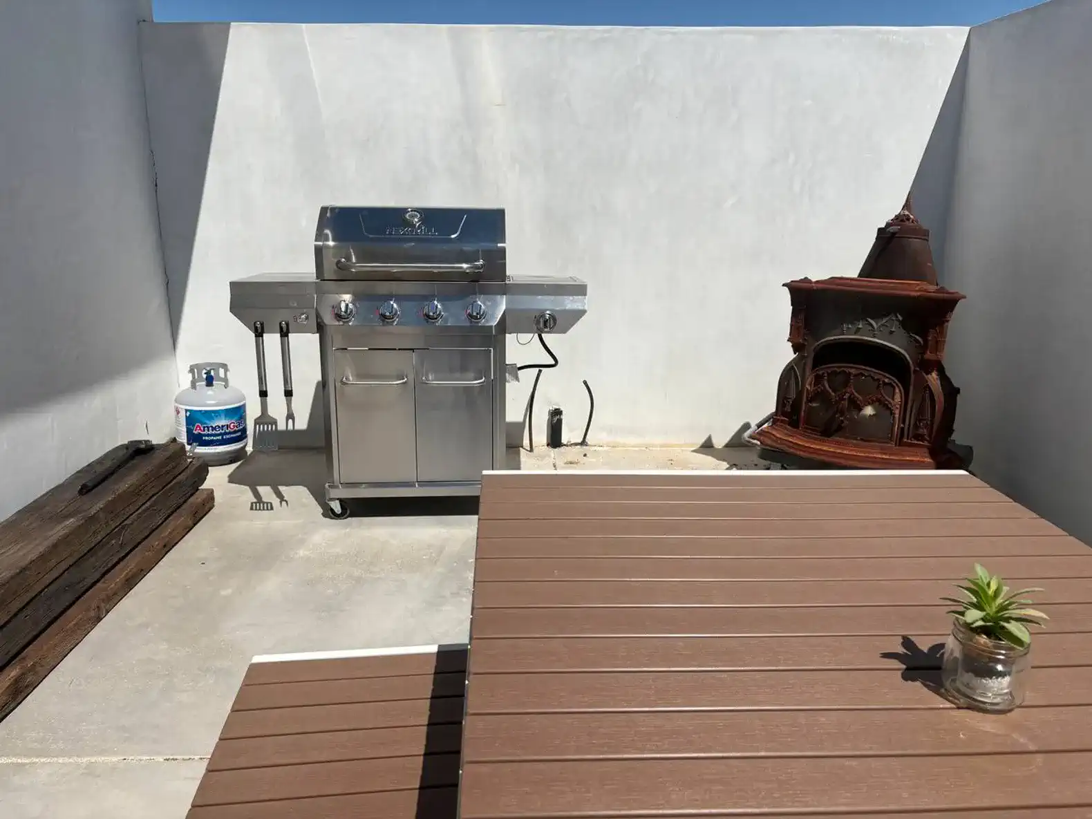Outdoor grilling area with a barbecue grill and seating