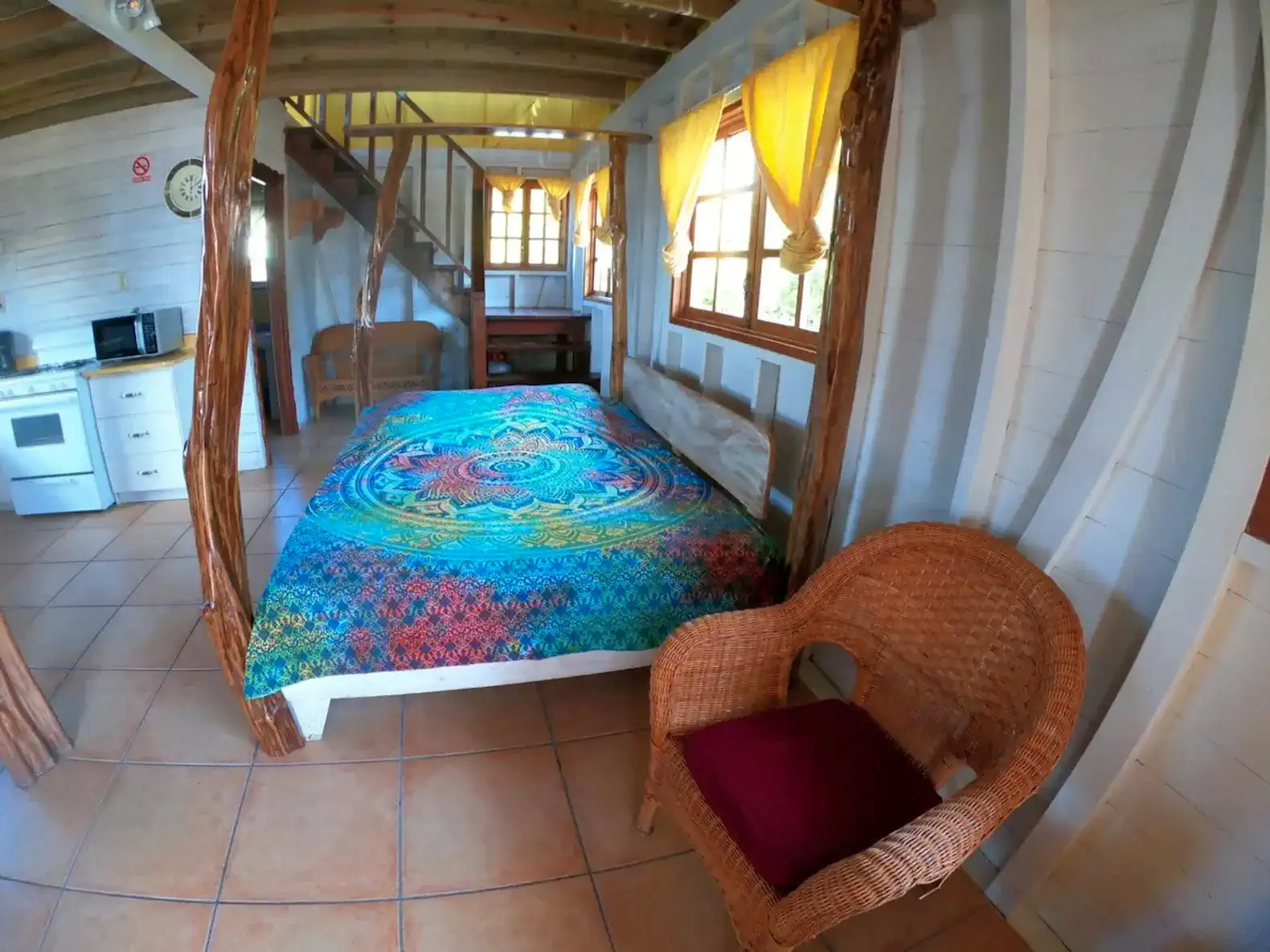 Cozy bedroom with colorful bedding and wicker chair
