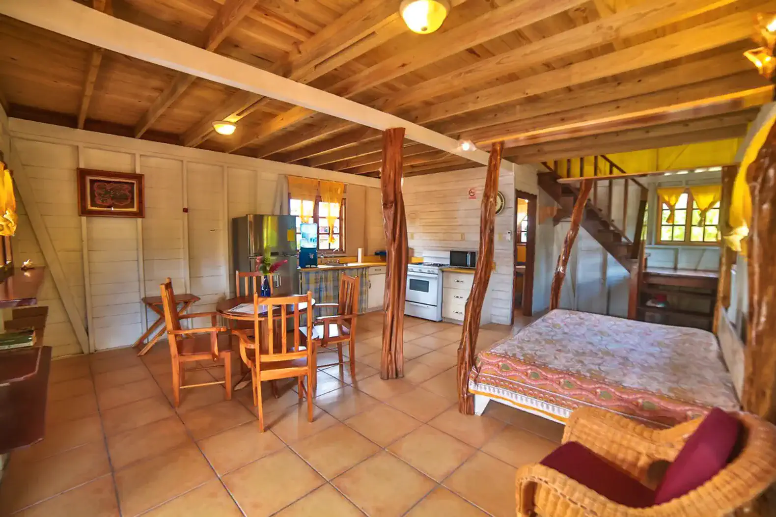 Cozy interior featuring a dining area, kitchen appliances, and a sleeping space