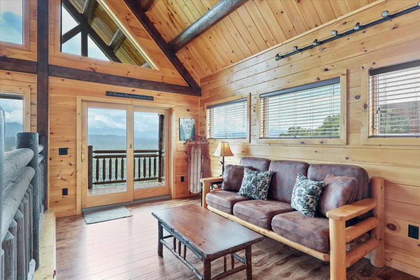 Cozy living room with wooden accents and large windows showcasing mountain views
