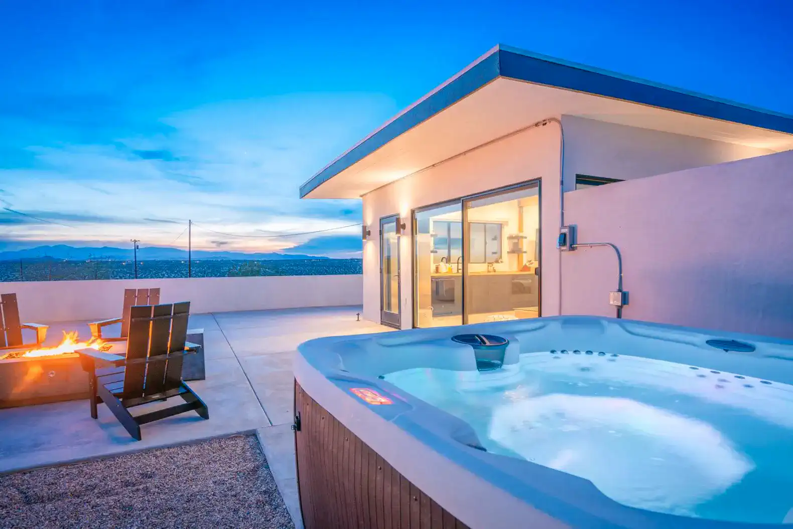 Hot tub beside a firepit with a stunning sunset view