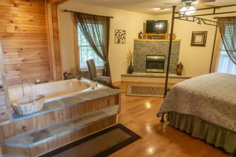 - Bedroom suite with in-room jacuzzi and fireplace view   - Cozy space designed for couples seeking relaxation   - Unwind in comfort with rustic charm and soft lighting