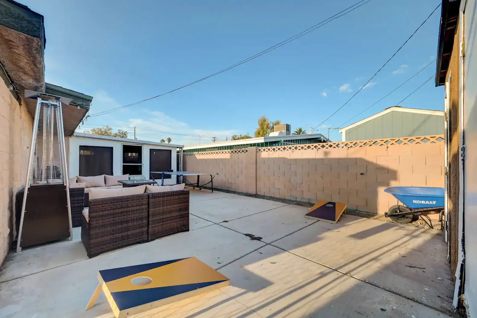 Spacious outdoor area with seating and cornhole game setup