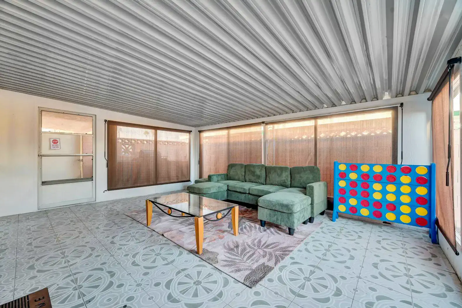 Cozy seating area with green couch and colorful game board