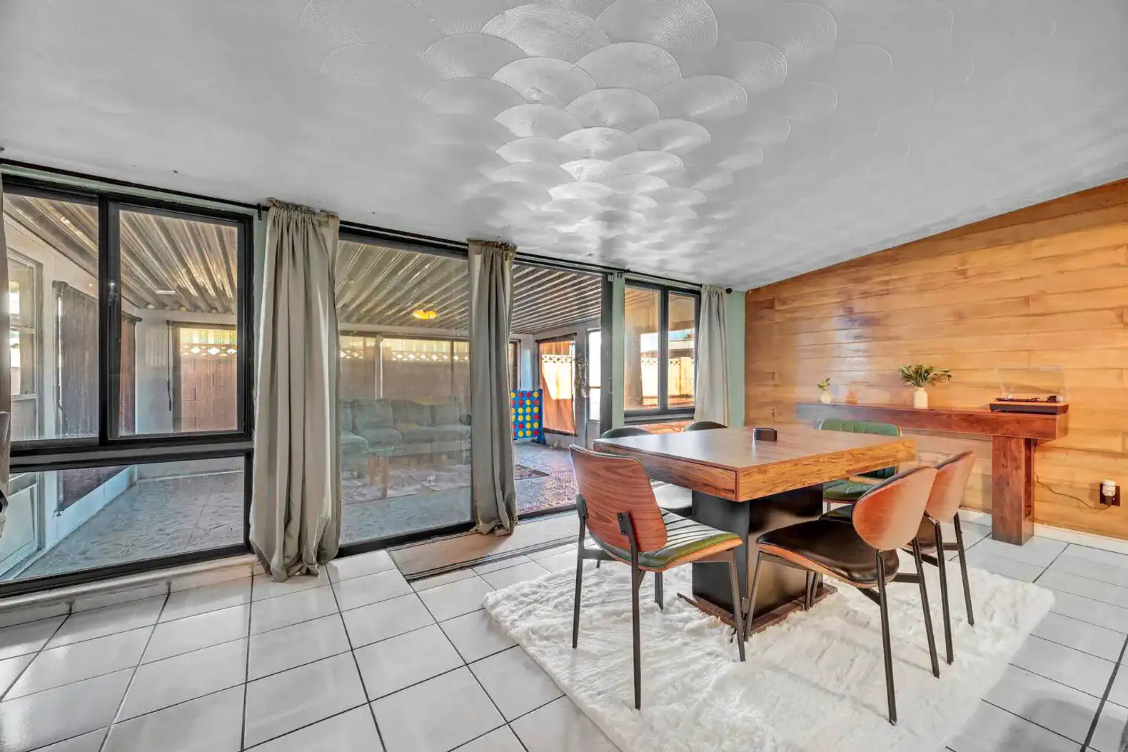 Bright dining area with large windows and wooden accents