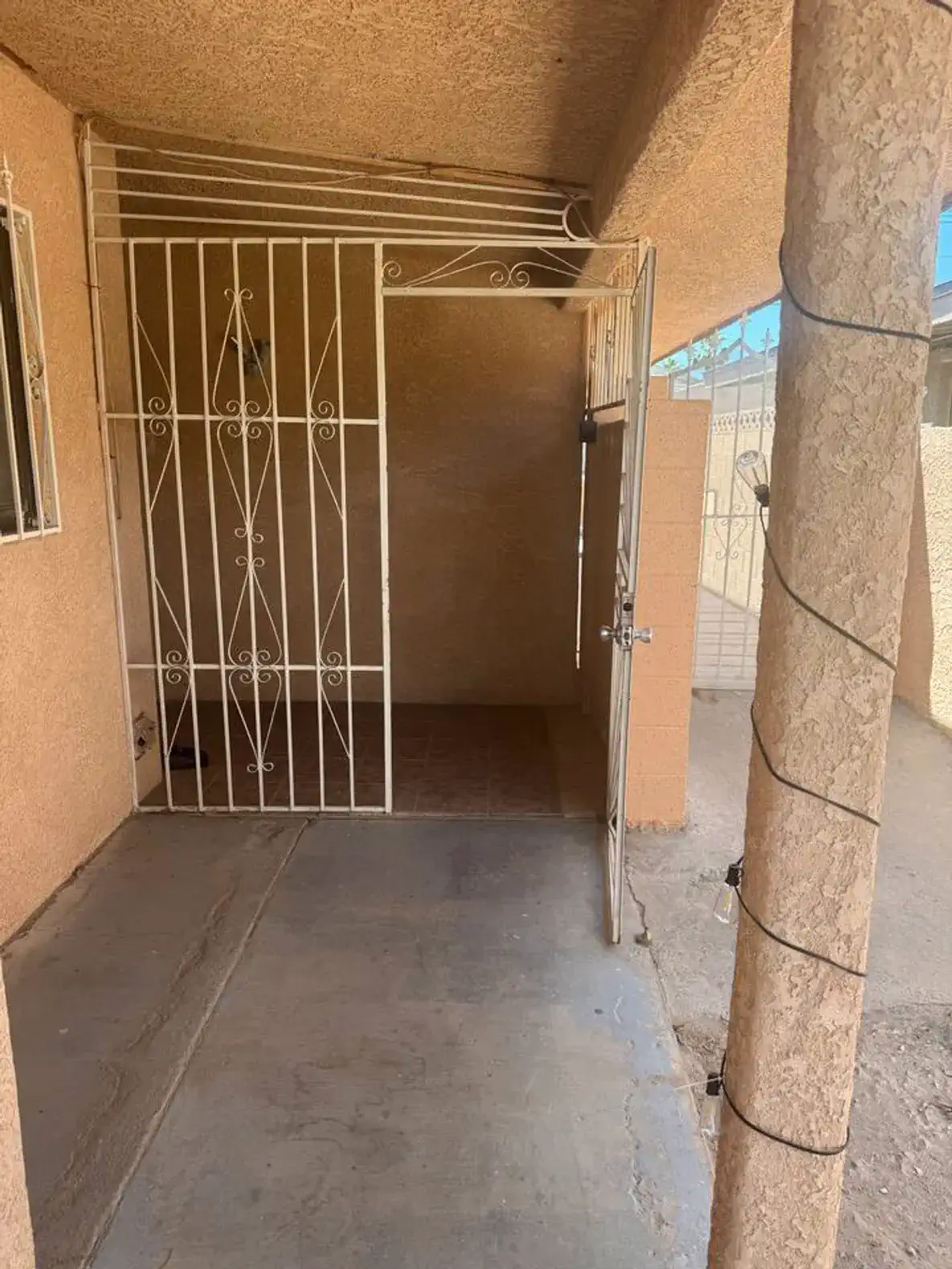 Entrance with security gate and tiled floor