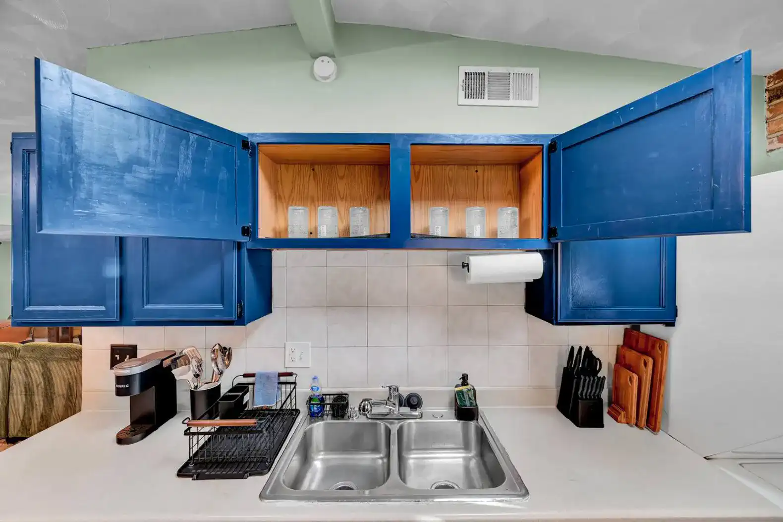 Bright kitchen with blue cabinets and double sink