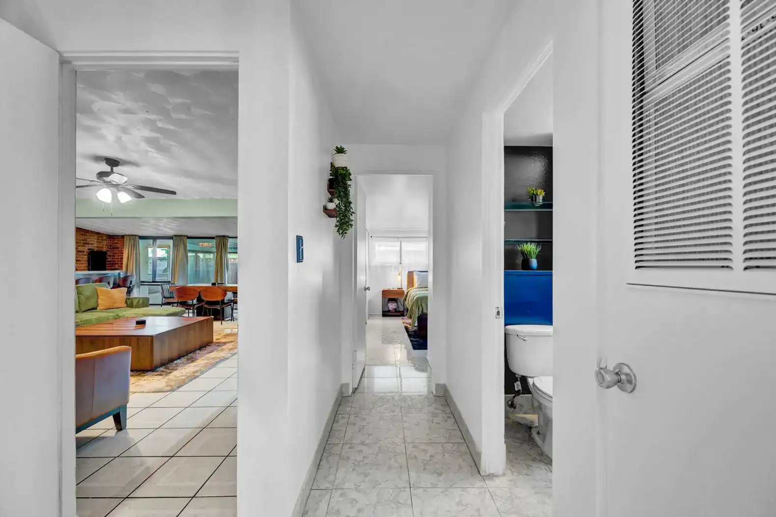 Bright hallway leading to living area and bathroom