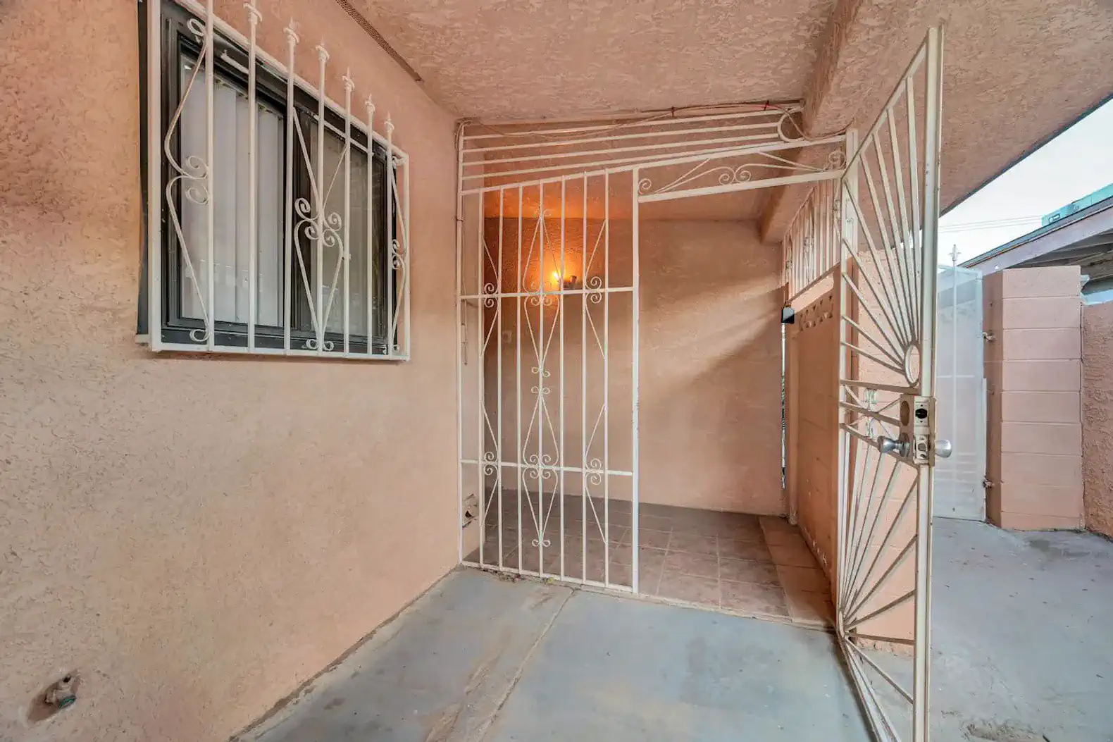 Entrance with decorative security gate and tiled floor