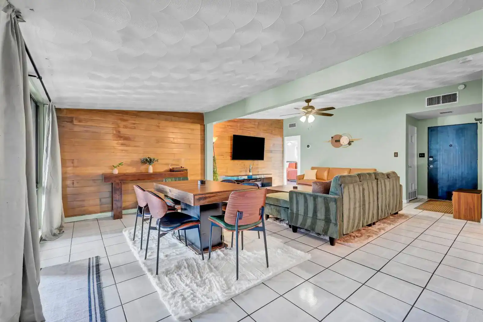 Spacious living and dining area with wooden accents and modern furnishings