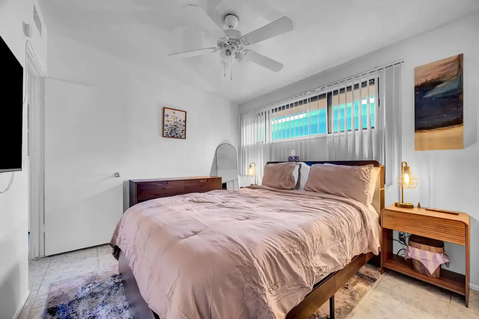 Cozy master bedroom with a large bed, natural light, and modern decor