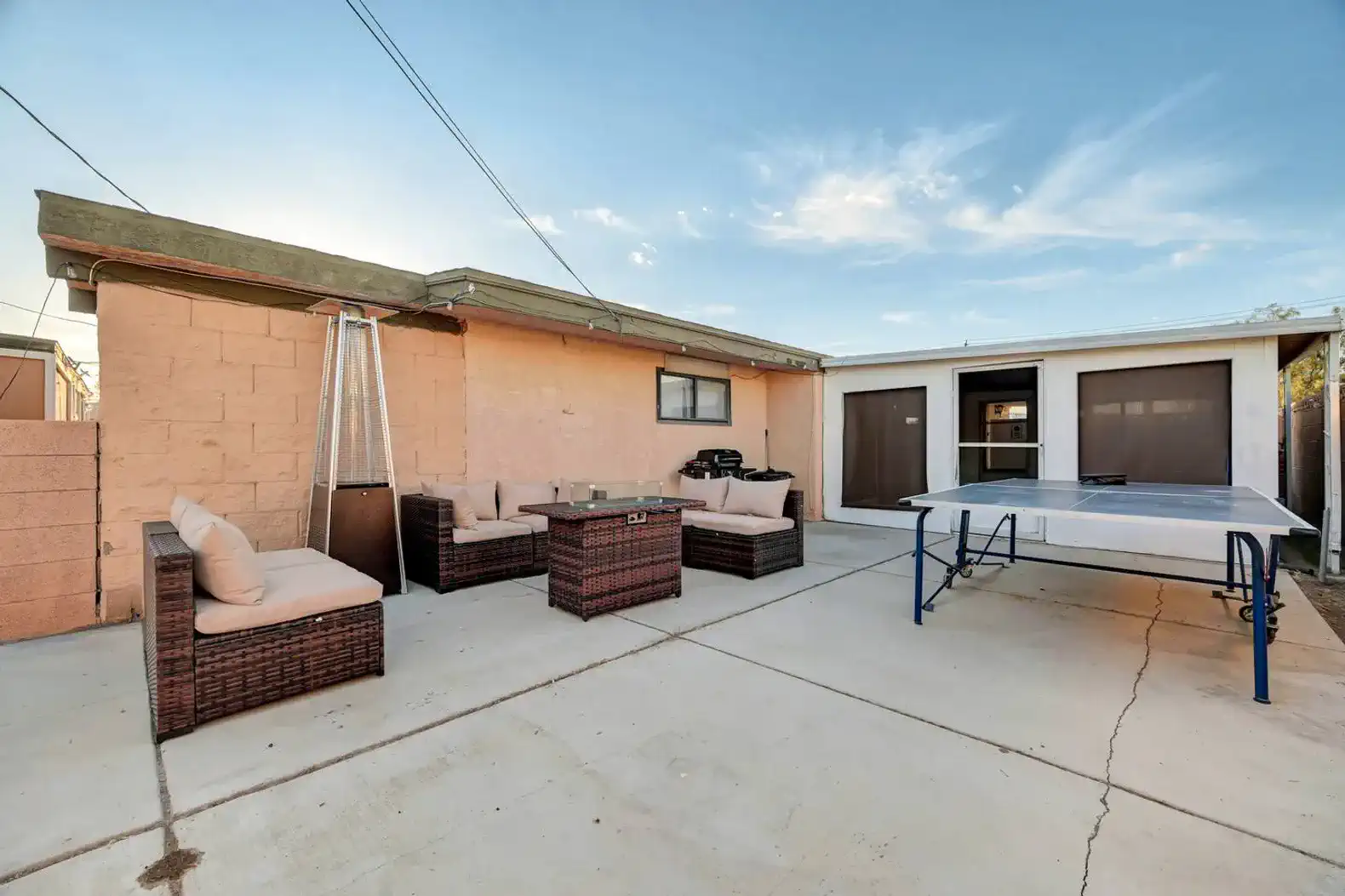 Outdoor seating area with a ping pong table and patio furniture