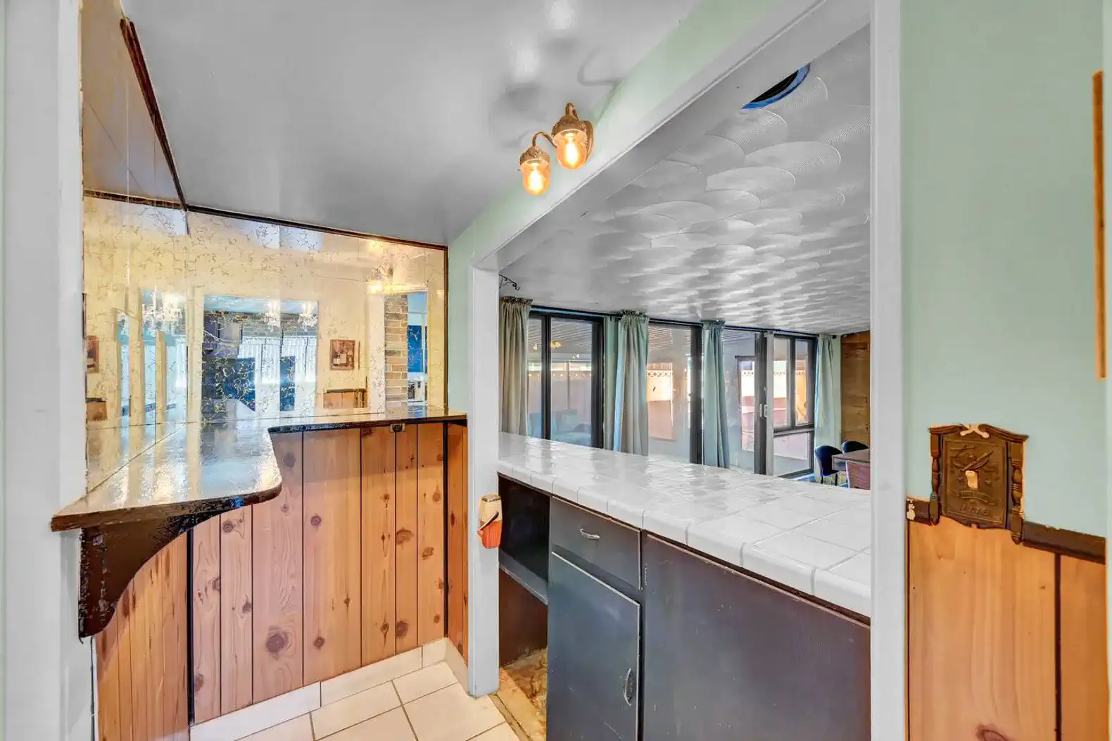 Cozy bar area with tiled counter and wooden accents