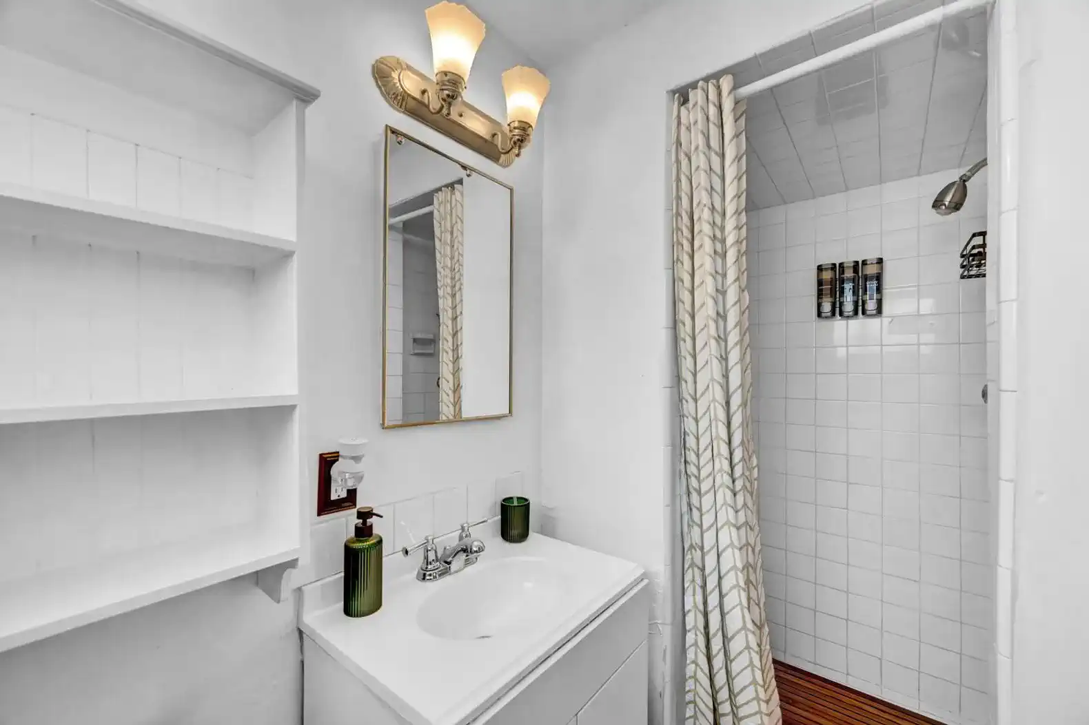 Bright bathroom with a shower, mirror, and shelving