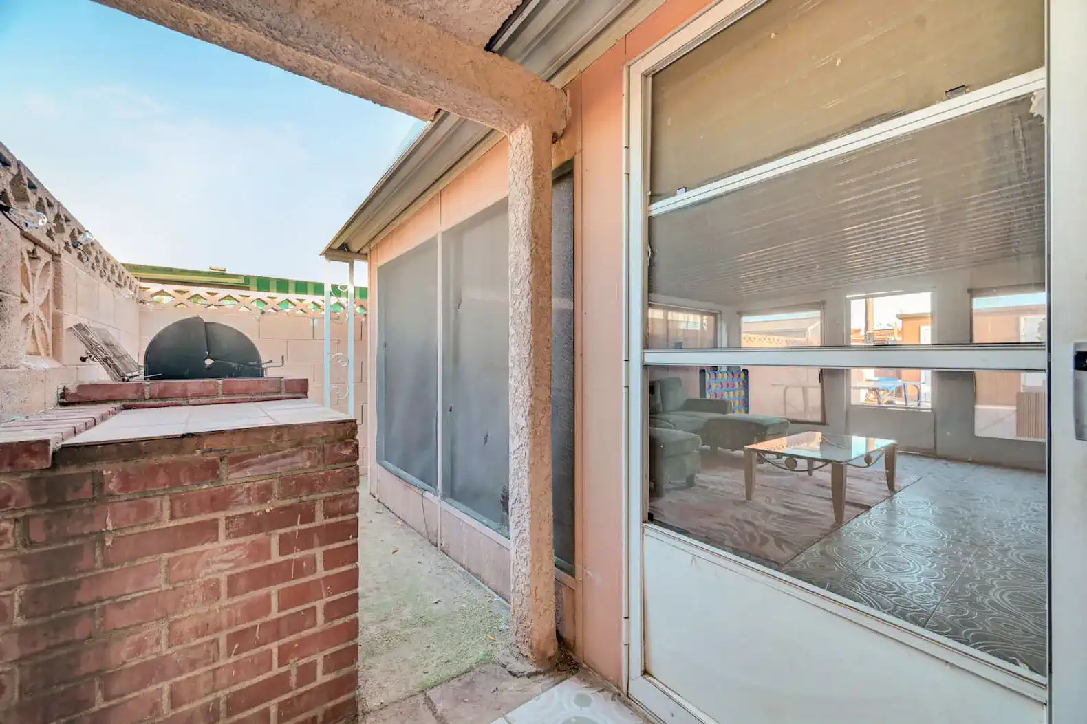Screened patio area with a view of the living room and outdoor space
