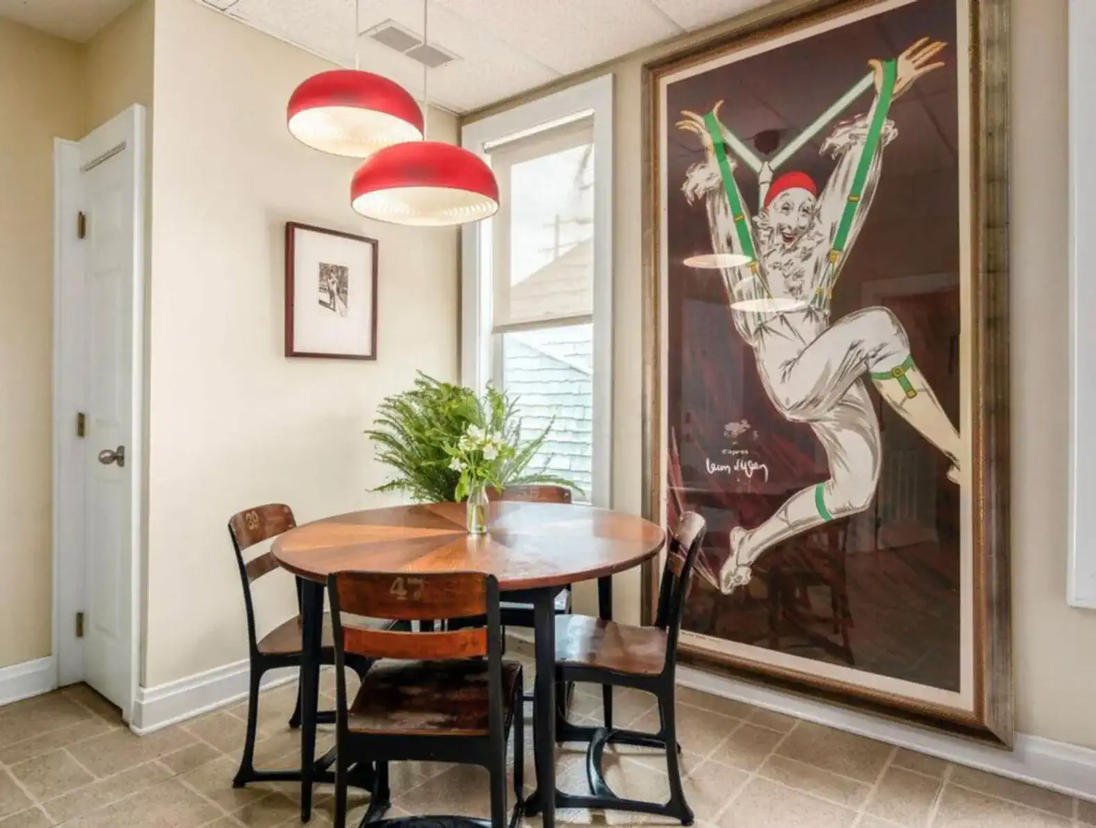 Cozy dining area with a round table and artistic wall decor