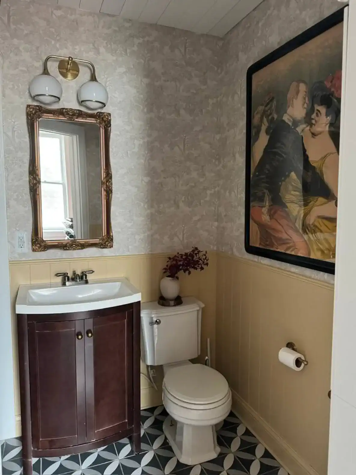 Stylish half bath with vintage decor and patterned floor tiles