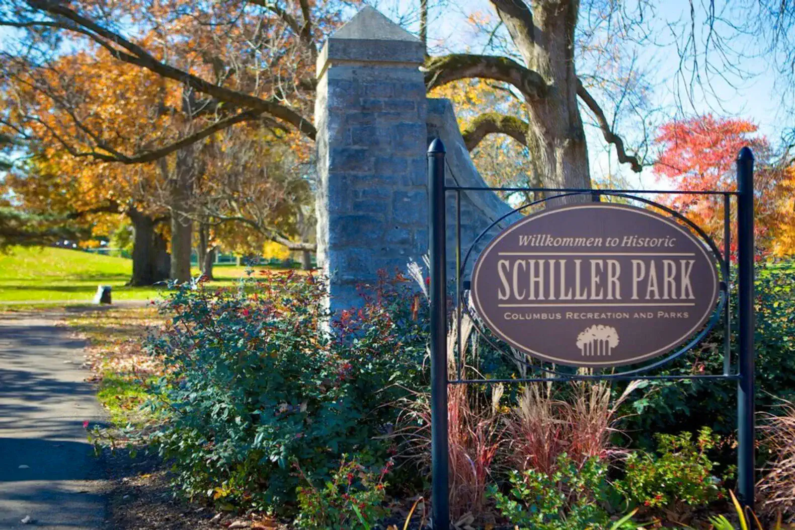 Entrance sign to Schiller Park surrounded by colorful autumn foliage