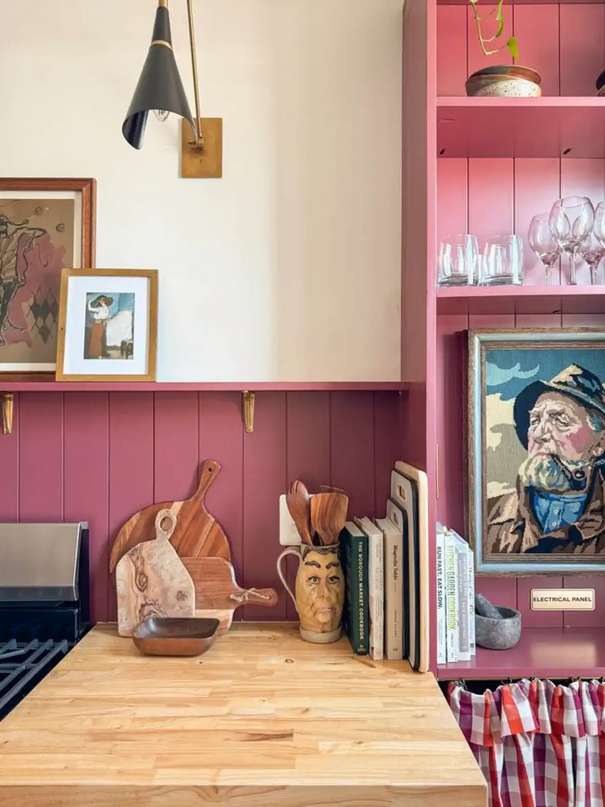 Charming kitchen corner with wooden countertop, decorative items, and pink walls