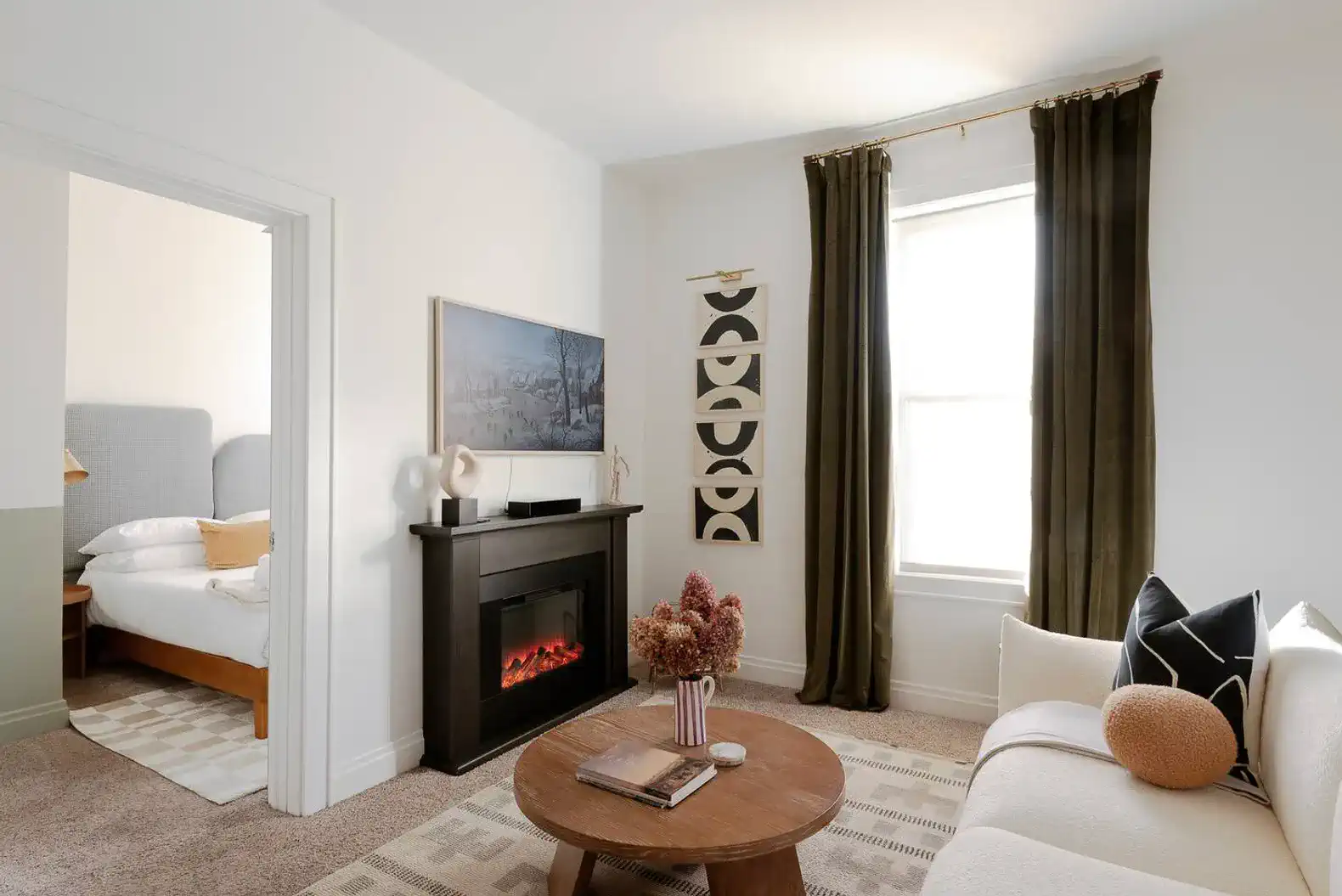 Cozy living area with a modern fireplace and natural light from the window