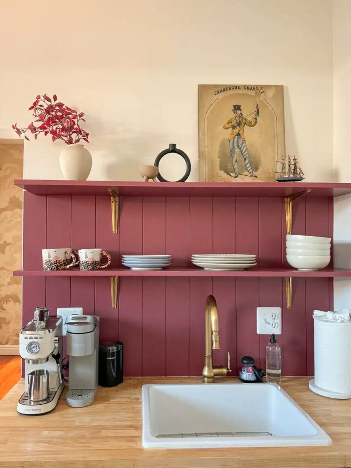 Stylish kitchen shelf with dishes, coffee maker, and decorative items