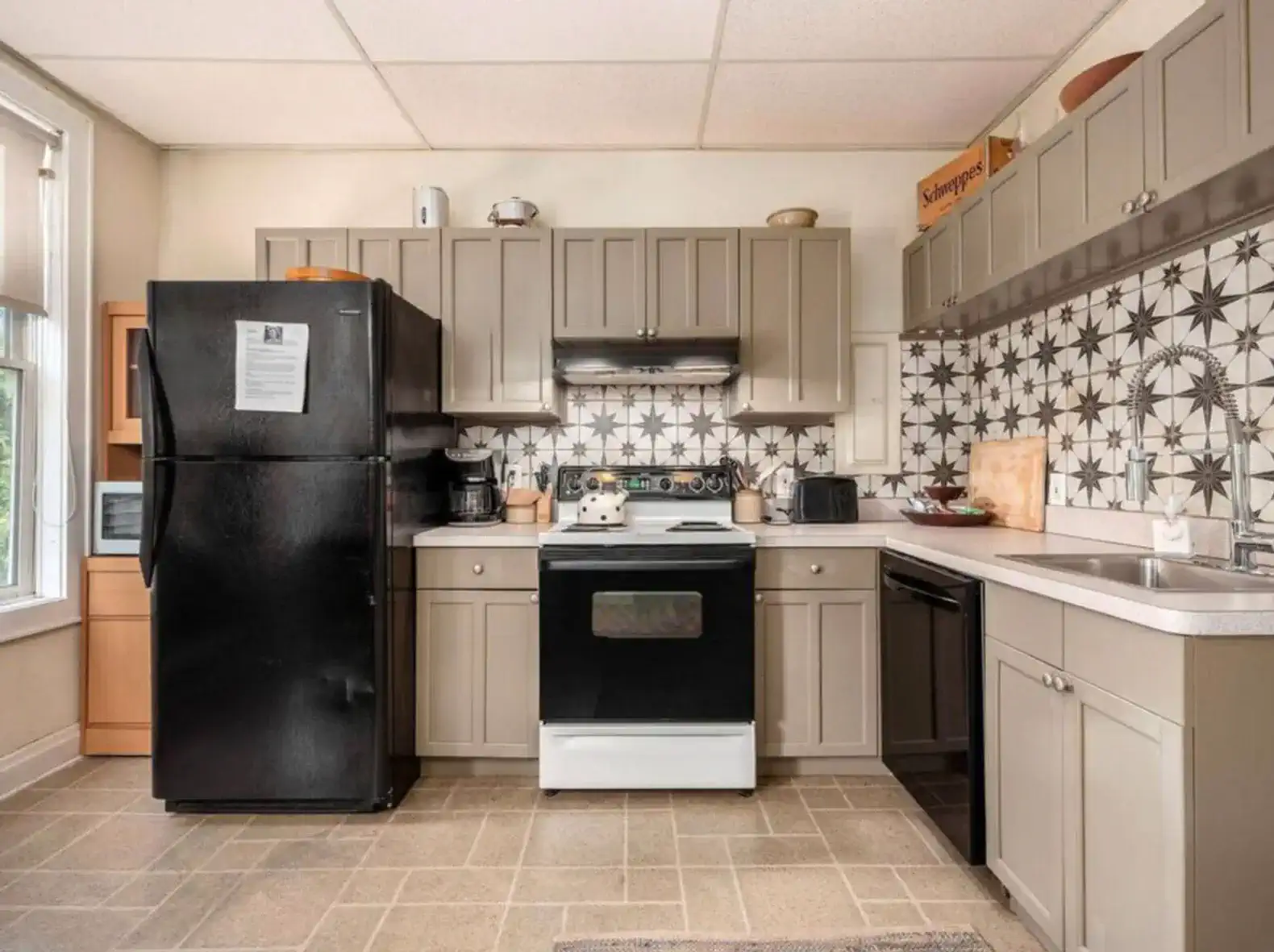 Cozy kitchen with modern appliances and patterned backsplash