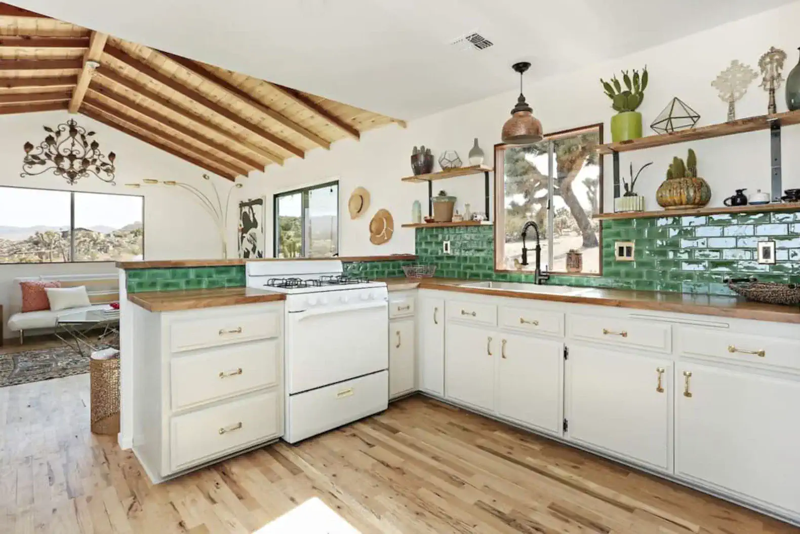 Bright kitchen with green tile backsplash and wooden accents