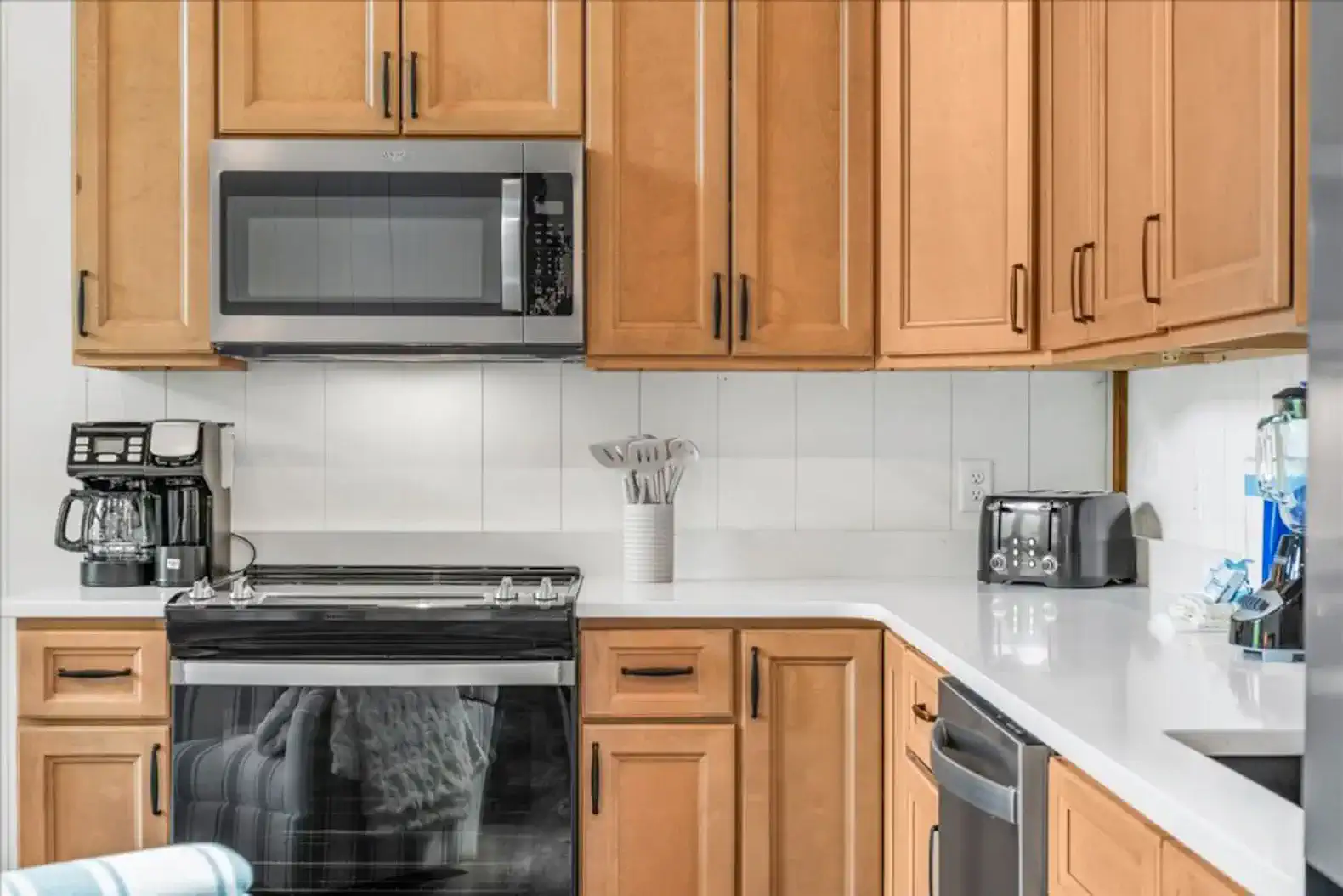 You'll find a toaster, blender, can opener, coffee machine, utensils, microwave, stove, oven, fridge, freezer, and some basic cleaning necessities. 