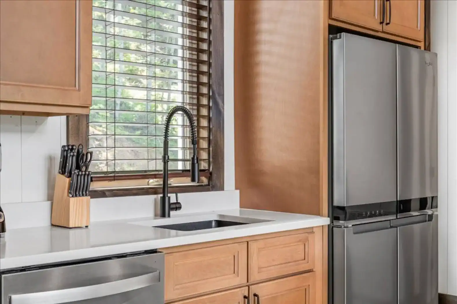 Modern kitchen with stainless steel appliances and wooden cabinetry