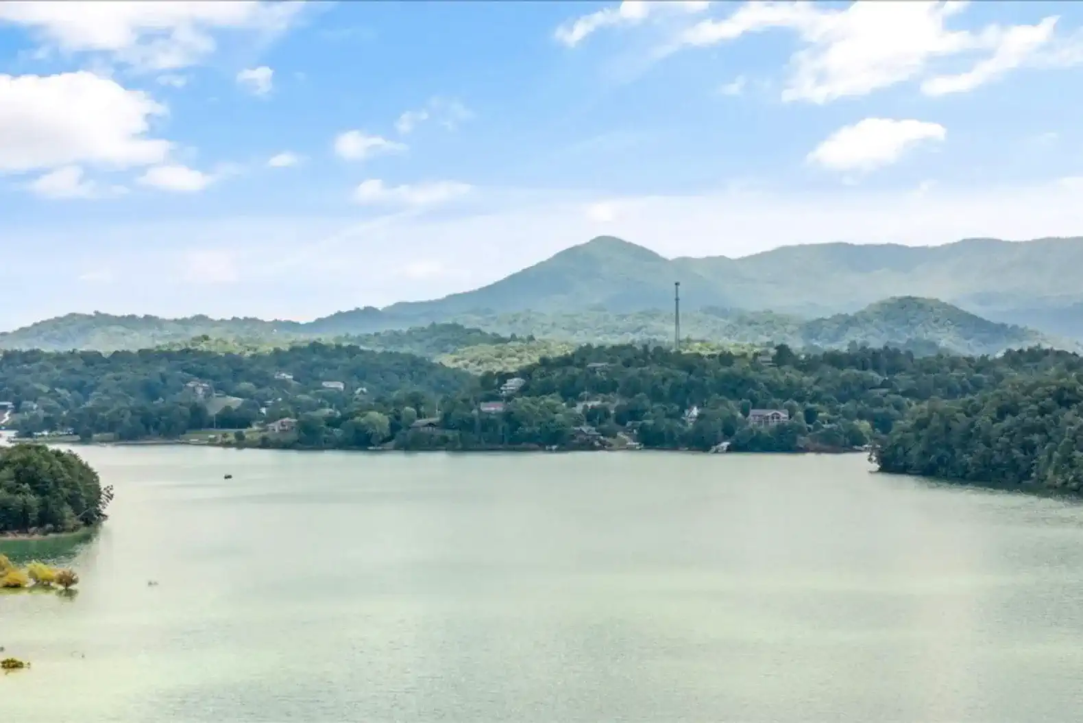 Scenic view of Lake Douglas surrounded by lush green mountains
