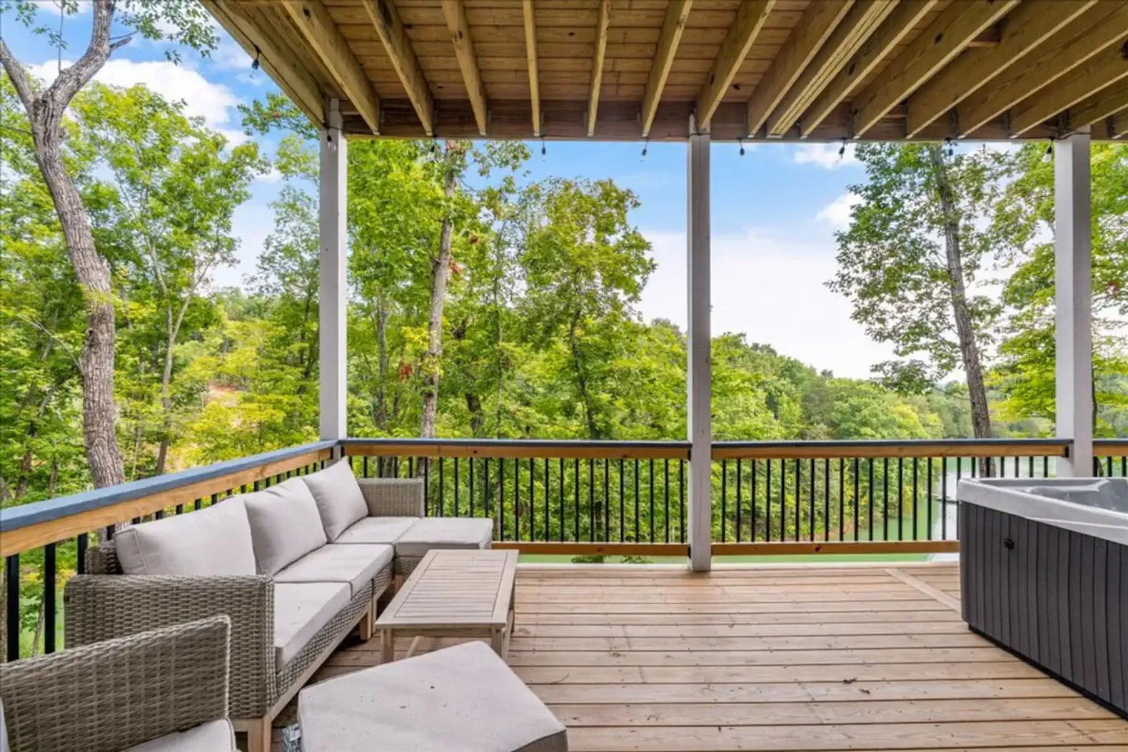 Lowest level deck with seating, private hot tub, and a water view (see desription)