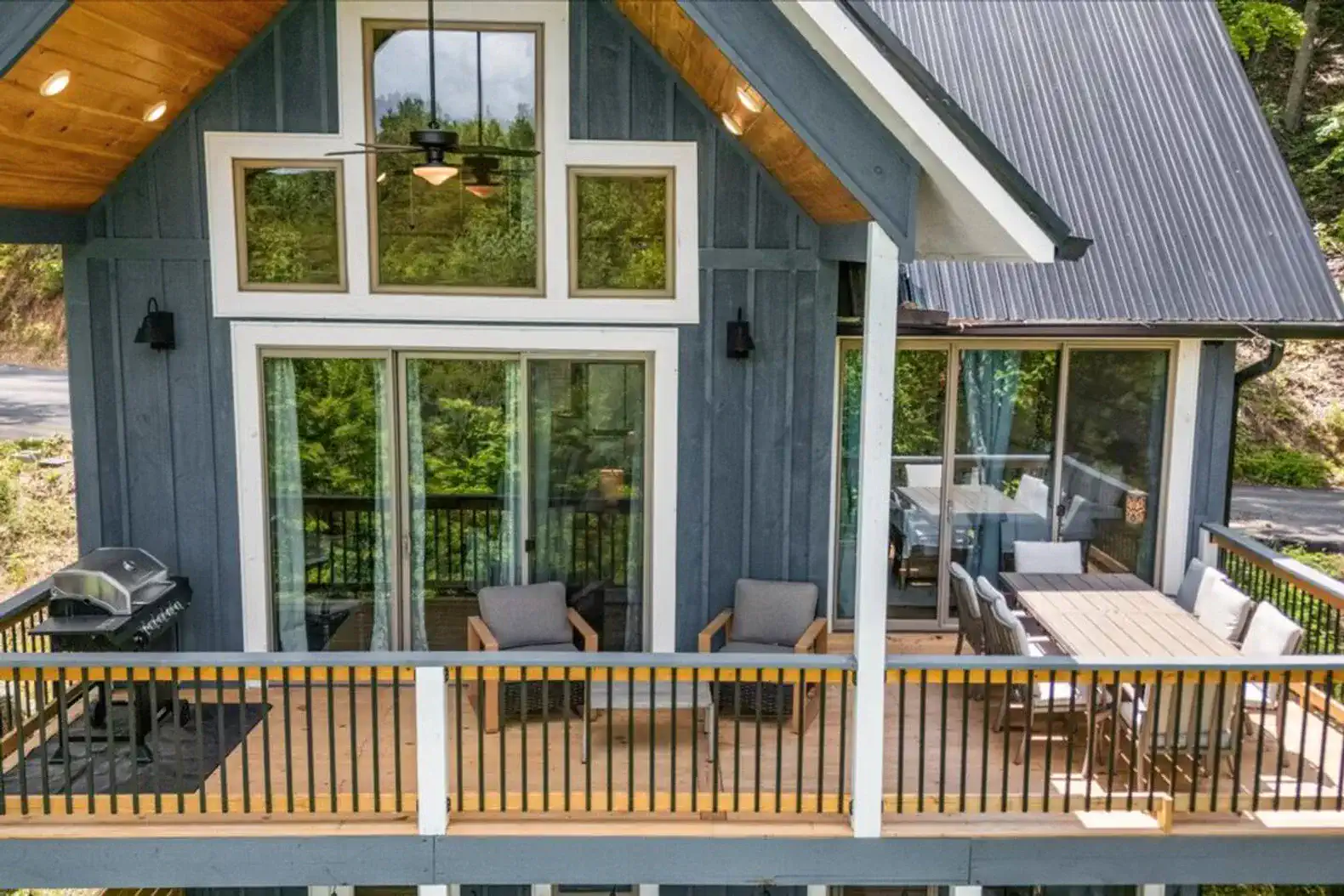 Main level back deck with a grill, outdoor dining, and seating area so you can enjoy the lake air!